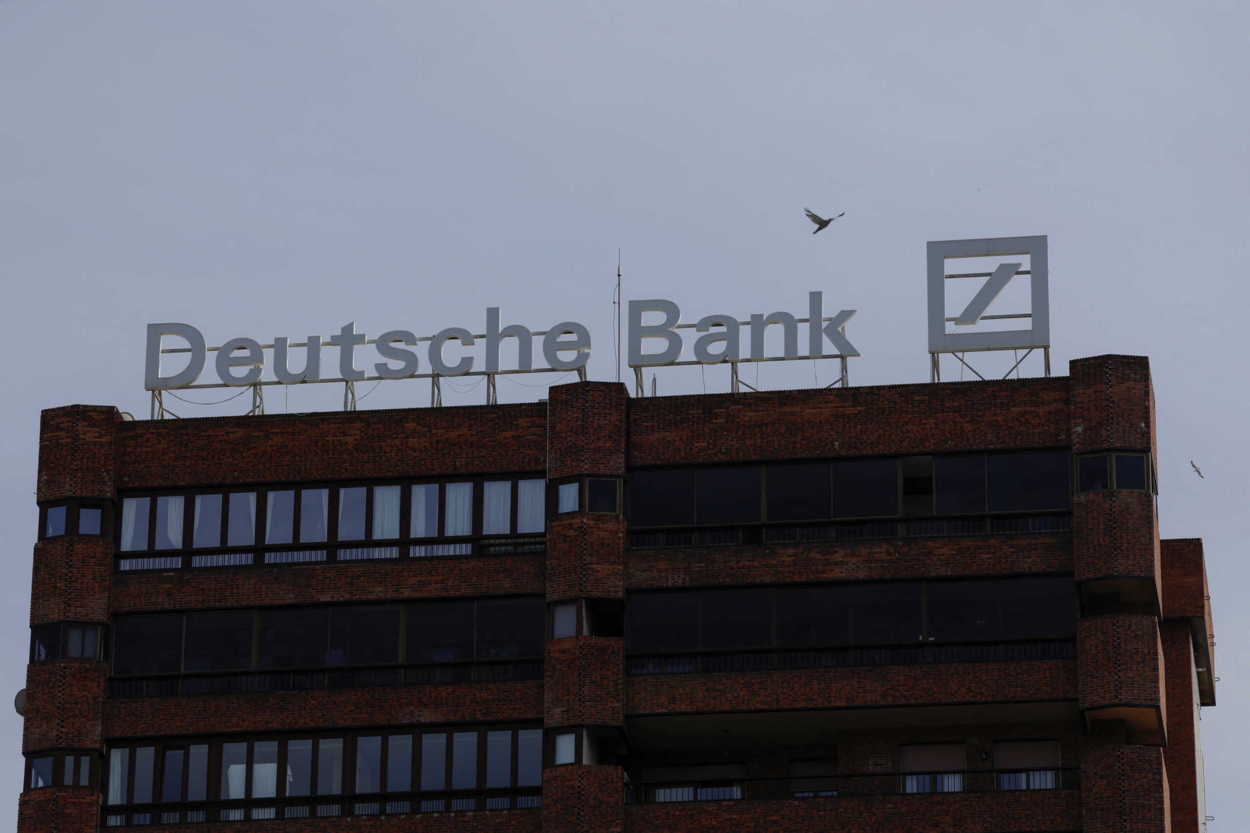 The logo of Deutsche Bank is seen on the roof of a building outside a Deutsche Bank branch office in Malaga, Spain, April 24, 2024. REUTERS