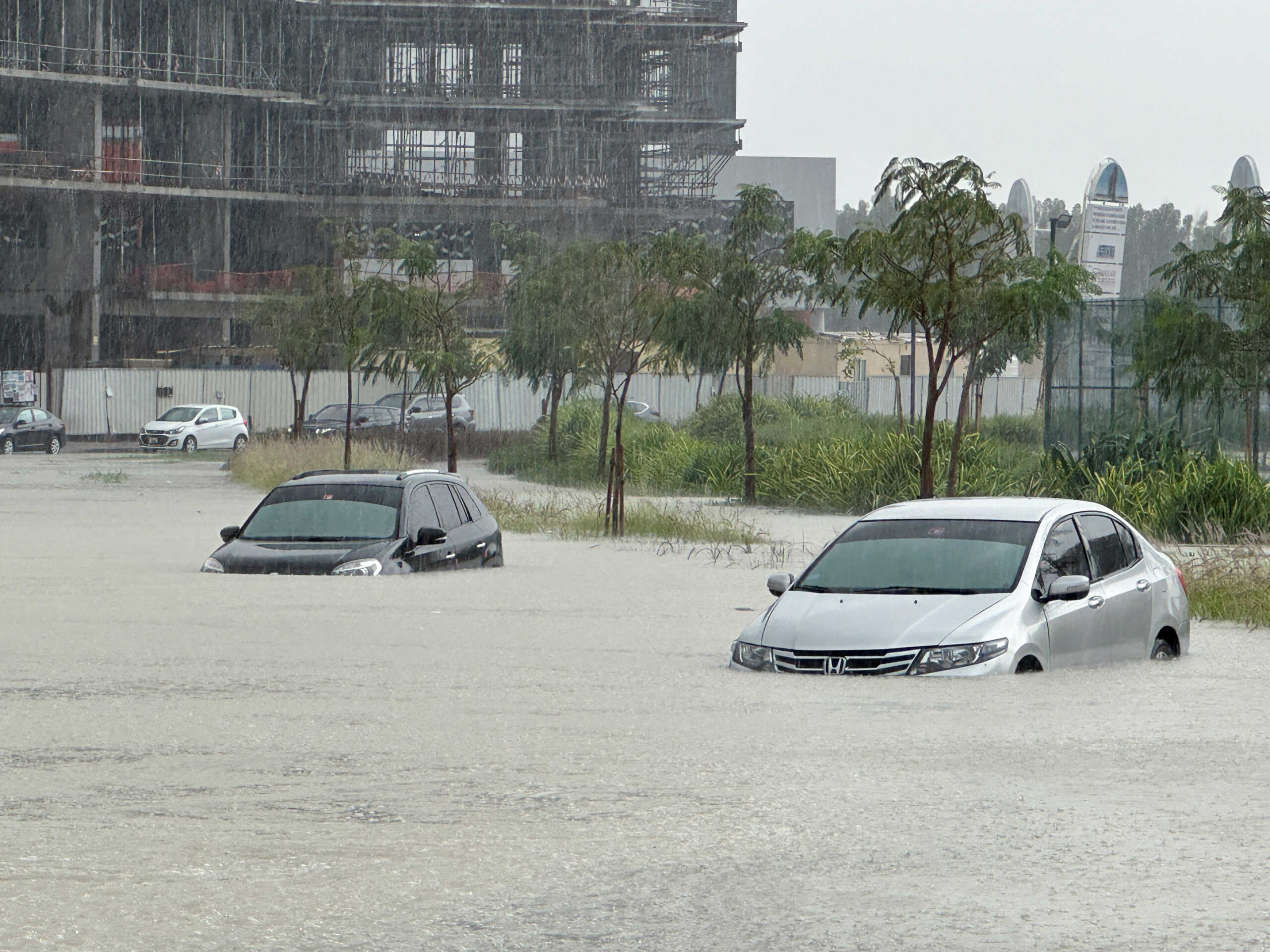 Cars drive through a flooded street during a rain storm in Dubai, United Arab Emirates, April 16, 2024. REUTERS