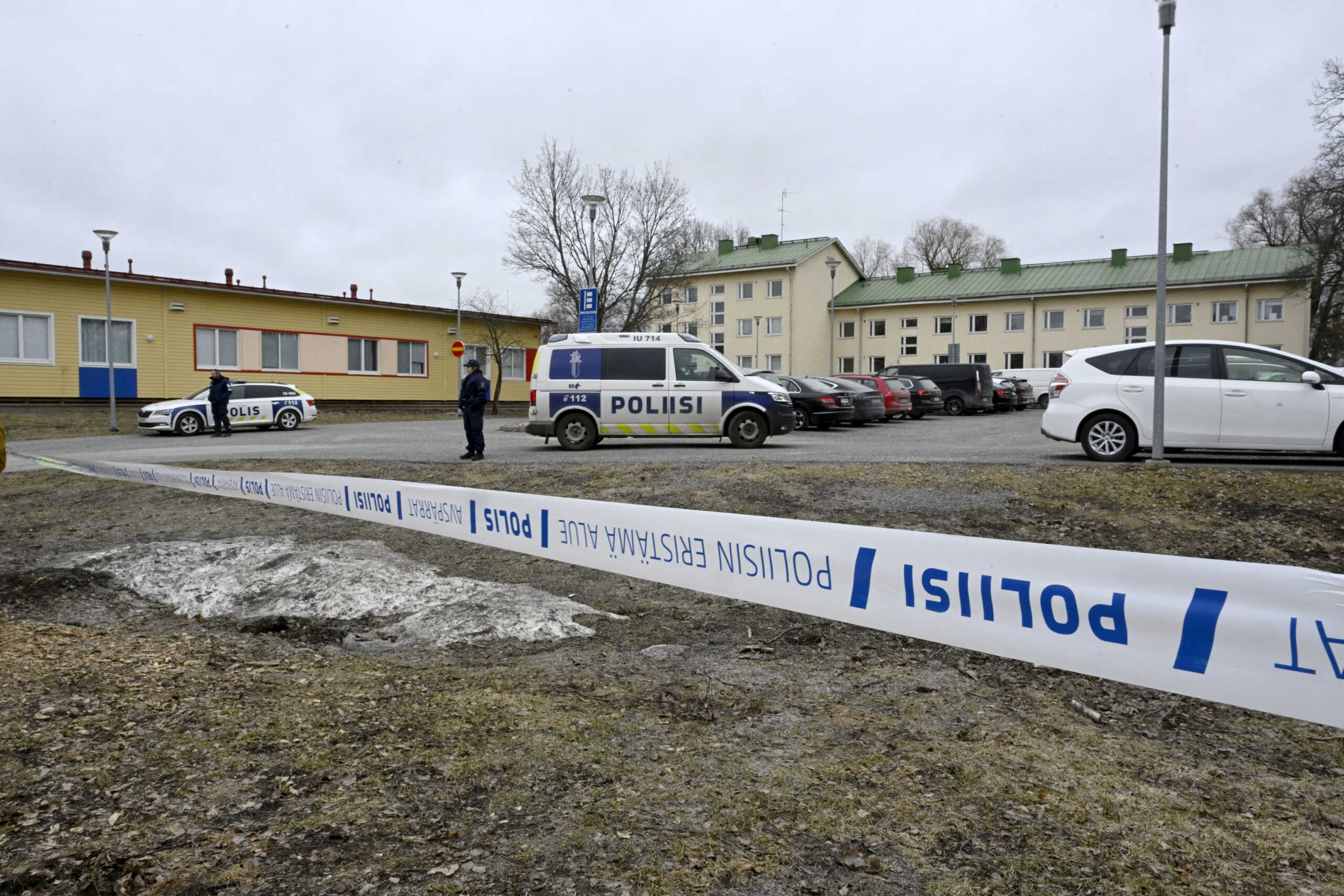 Police officers guard the scene behind police tapes at the Viertola comprehensive school in Vantaa, Finland, on April 2, 2024. Three minors were injured in a shooting at the school on Tuesday morning. A suspect, also a minor, has been apprehended.   Lehtikuva