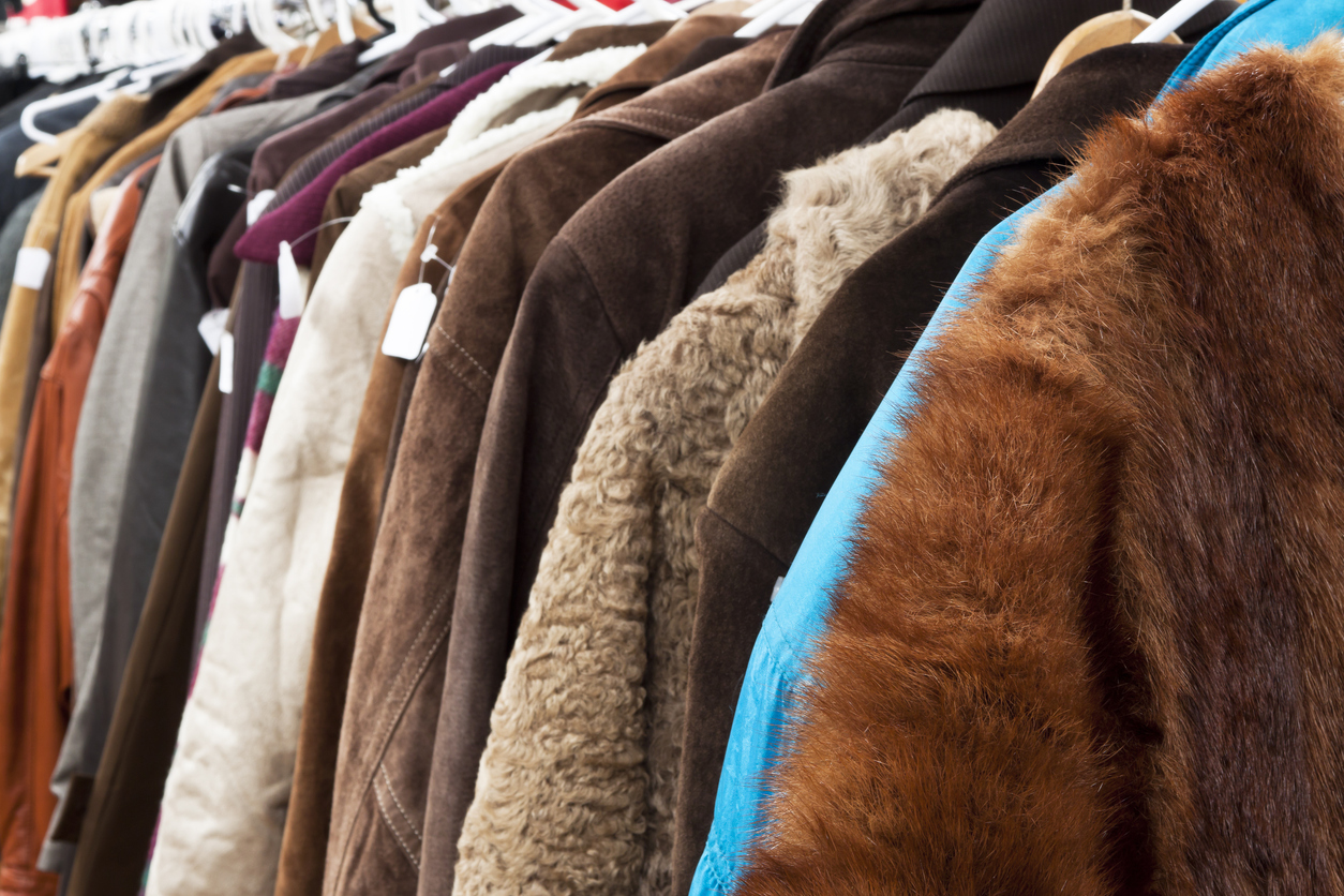 Close up secondhand winter coatsand jackets hanging the shop, full frame horizontal composition