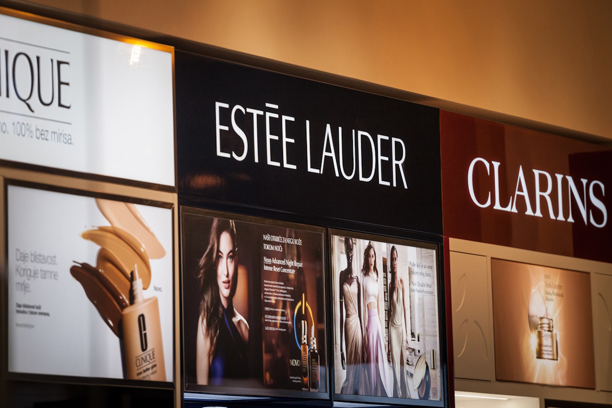 Picture of a sign with the logo of Estee Lauder and products for sale at a retailer in Belgrade. The Estee Lauder Companies Inc. is an American multinational manufacturer and marketer of prestige skincare, makeup, fragrance and hair care products, based in Midtown Manhattan, New York City.