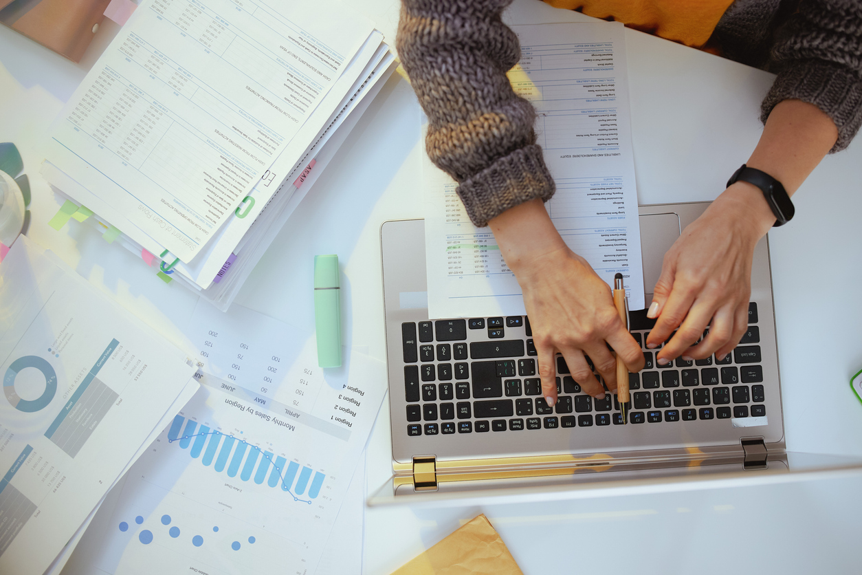 accountant woman with documents and laptop working.
