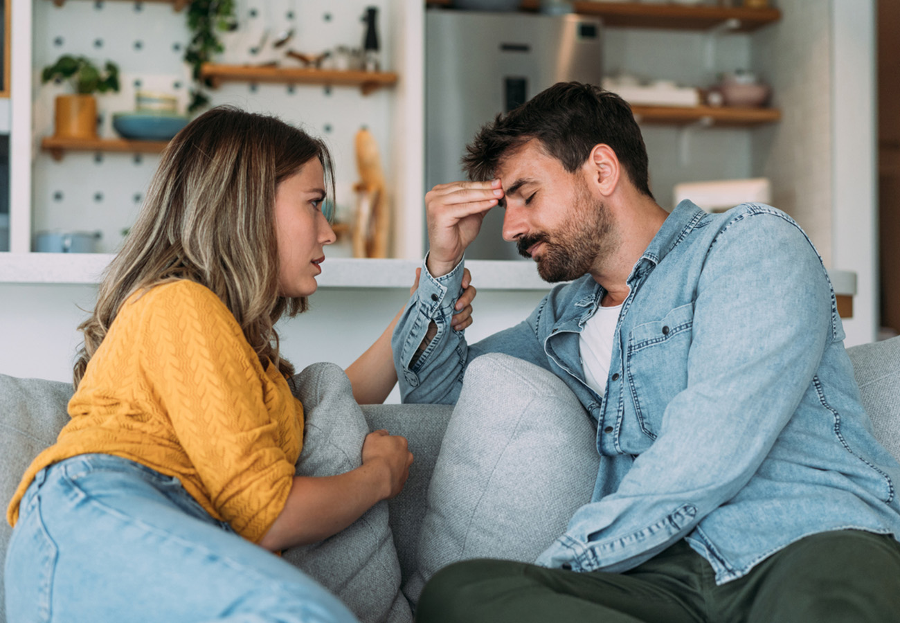Shot of young wife expressing empathy and compassion to her sad frustrated husband.