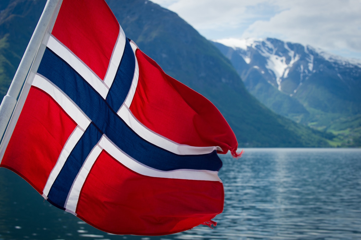 Norwegian flag on the back of a ferry cruising the fjords