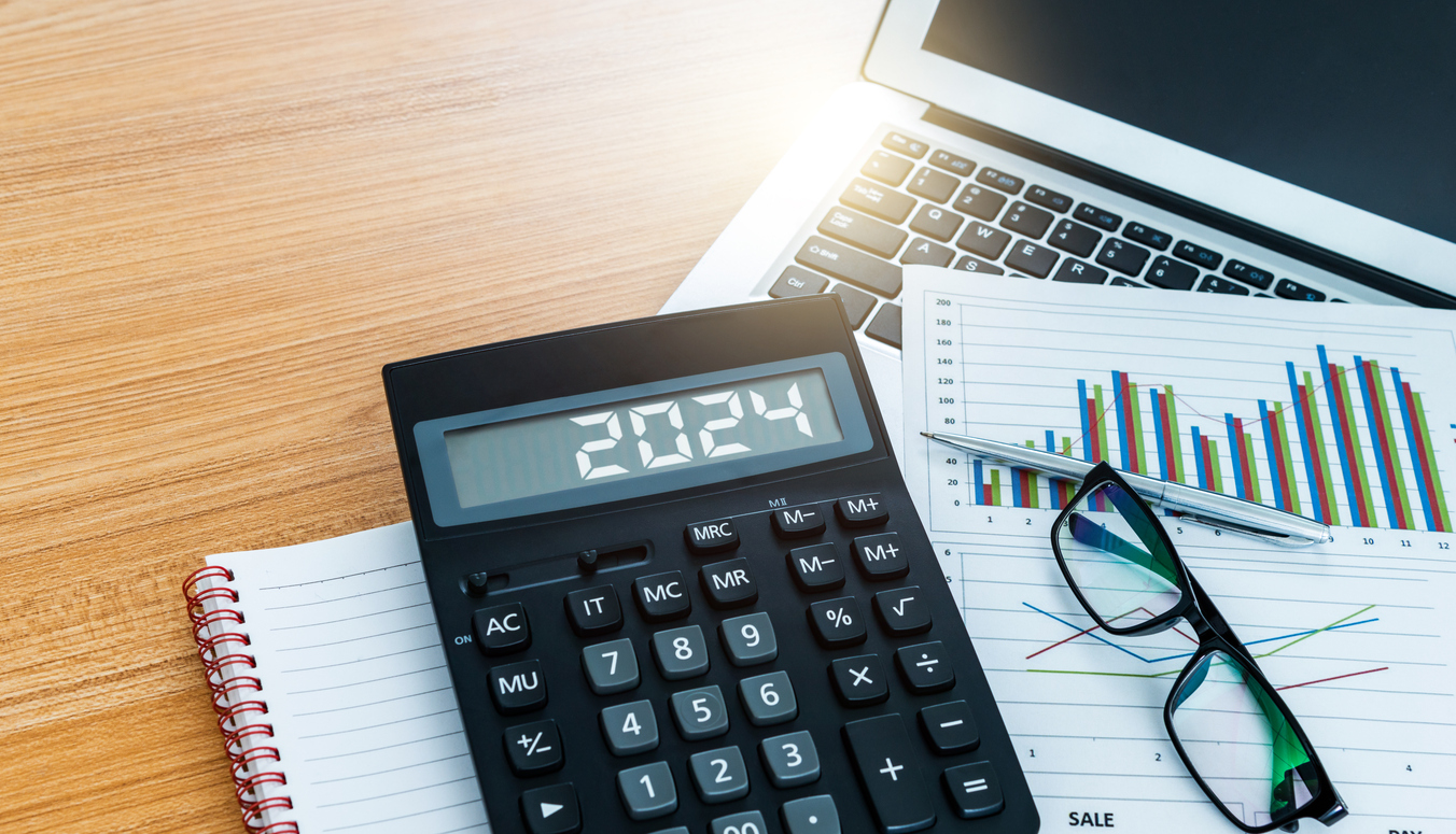 New year number 2024 on the calculator screen,  at financial analysis desk