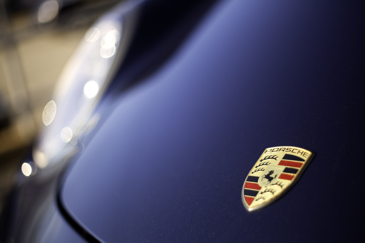Halifax, Nova Scotia, Canada - December 11, 2011: Porsche Logo on hood of Cayman R.  Porsche is a manufacturer of vehicles that includes the popular 911 series of vehicles, the Boxster, The Cayman, the Cayenne, and the Panamera.  The Porsche logo is one of the most recognized in the automotive business.