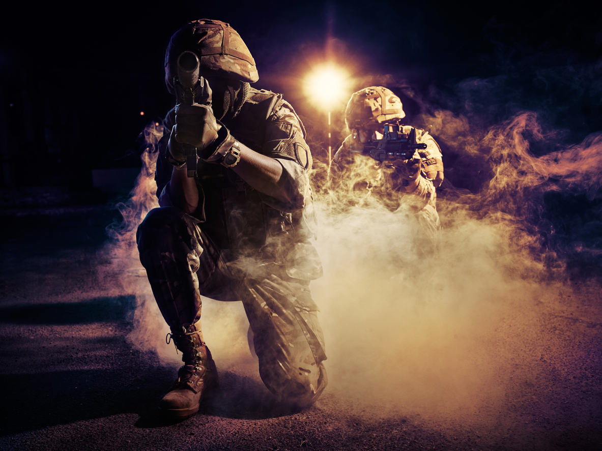 two soldiers with guns on the battlefield