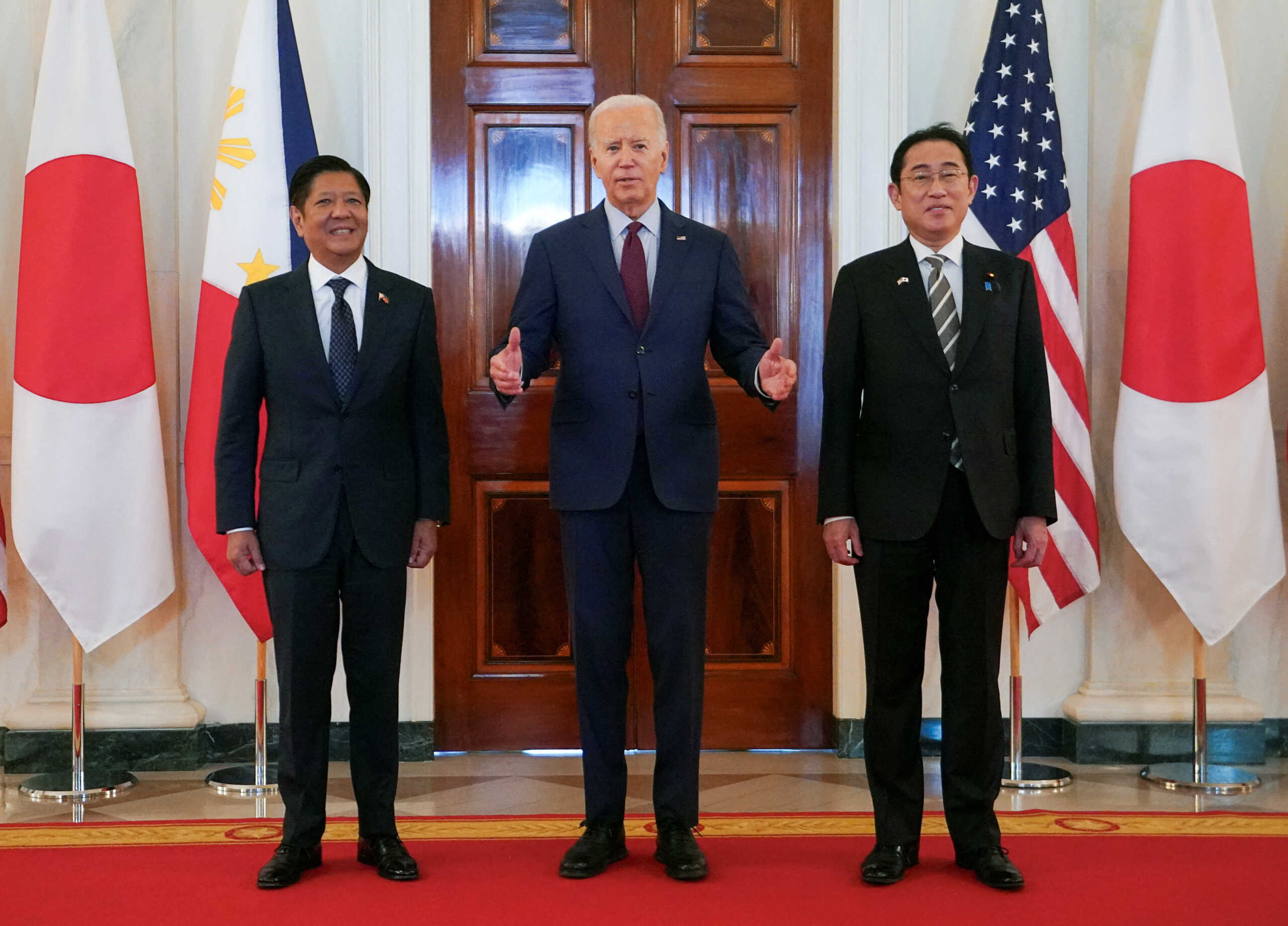U.S. President Joe Biden speaks while escorting Philippines President Ferdinand Marcos Jr. and Japan Prime Minister Fumio Kishida to their trilateral summit at the White House in Washington, U.S., April 11, 2024.  REUTERS