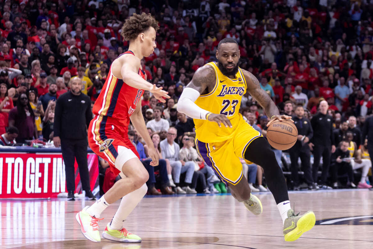 Apr 16, 2024; New Orleans, Louisiana, USA; Los Angeles Lakers forward LeBron James (23) dribbles against New Orleans Pelicans guard Dyson Daniels (11) during the second half of a play-in game of the 2024 NBA playoffs at Smoothie King Center. Mandatory Credit: Stephen Lew-USA TODAY Sports