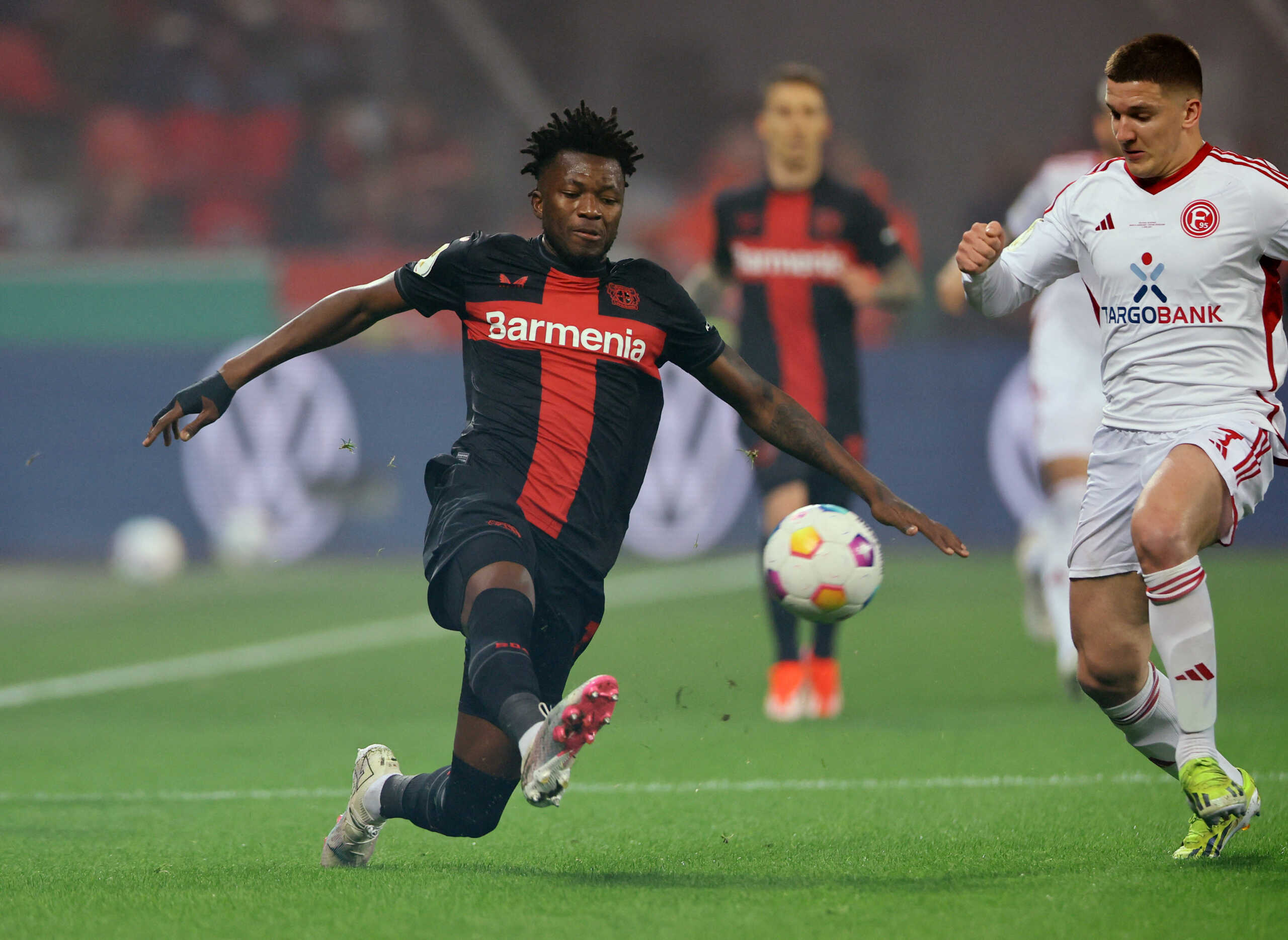 Soccer Football - DFB Cup - Semi Final - Bayer Leverkusen v Fortuna Duesseldorf - BayArena, Leverkusen, Germany - April 3, 2024 Bayer Leverkusen's Edmond Tapsoba in action with Fortuna Duesseldorf's Christos Tzolis REUTERS