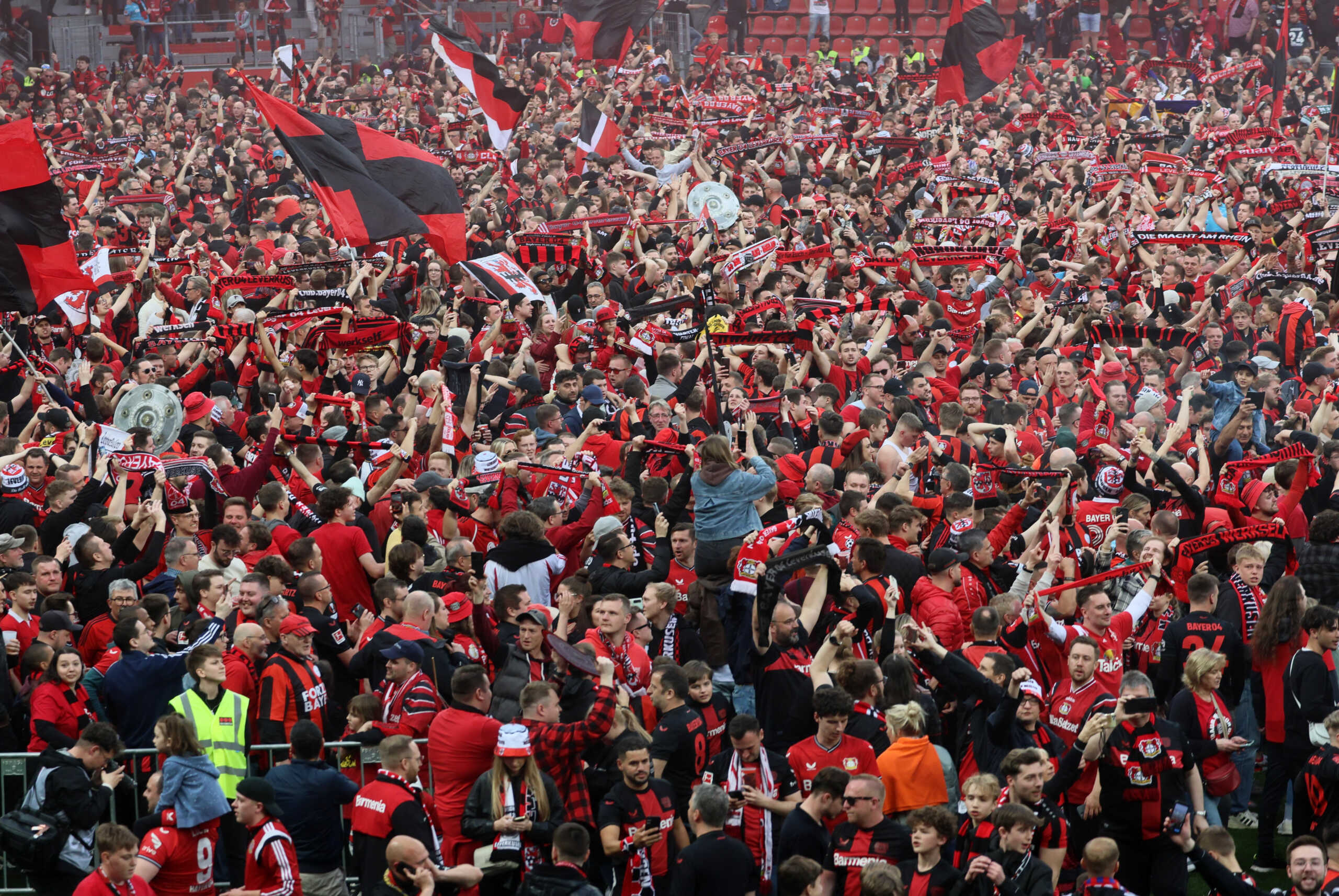 Soccer Football - Bundesliga - Bayer Leverkusen v Werder Bremen - BayArena, Leverkusen, Germany - April 14, 2024 General view of Bayer Leverkusen fans celebrating during a pitch invasion after winning the Bundesliga REUTERS
