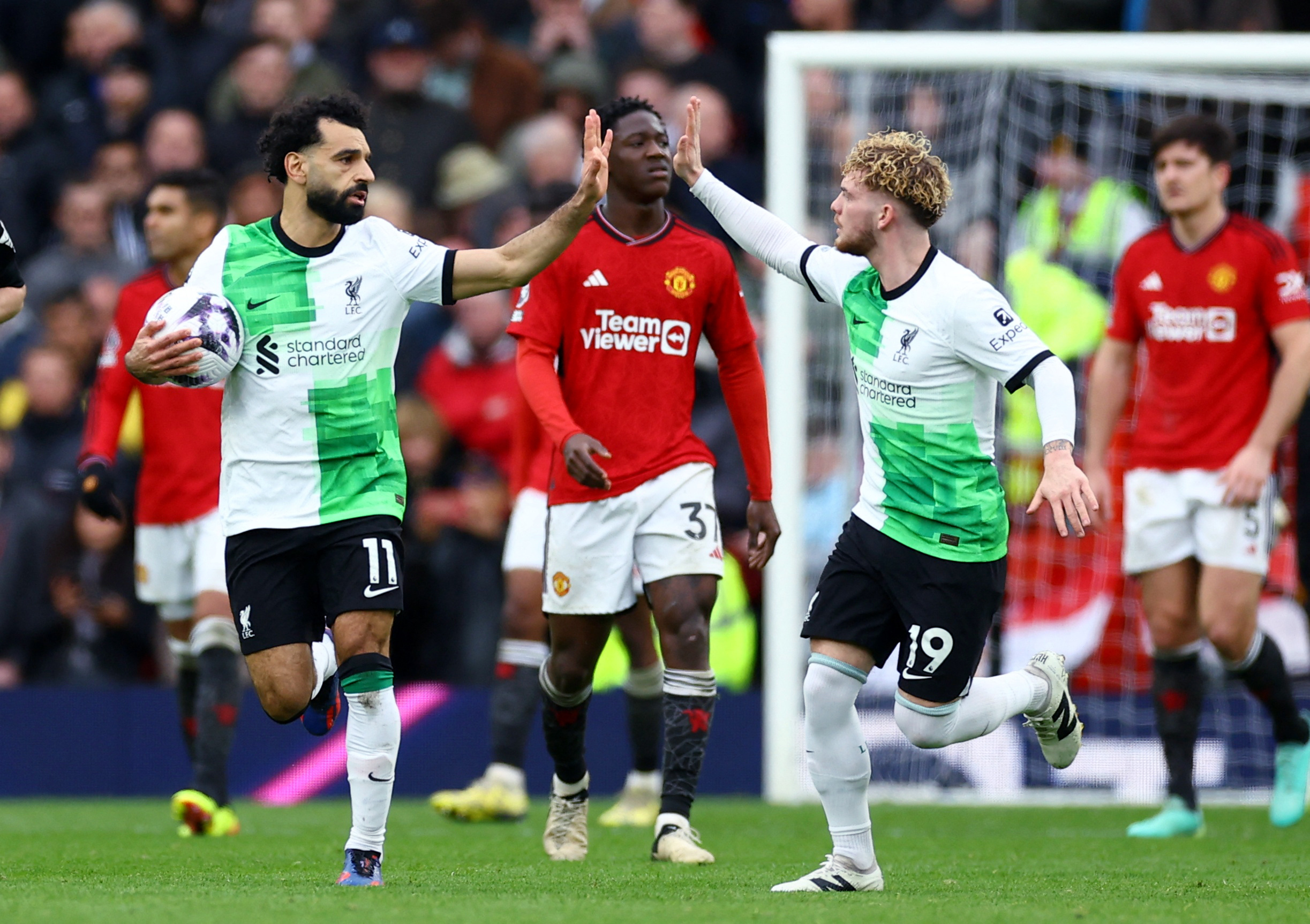Soccer Football - Premier League - Manchester United v Liverpool - Old Trafford, Manchester, Britain - April 7, 2024  Liverpool's Mohamed Salah celebrates scoring their second goal with Harvey Elliott REUTERS