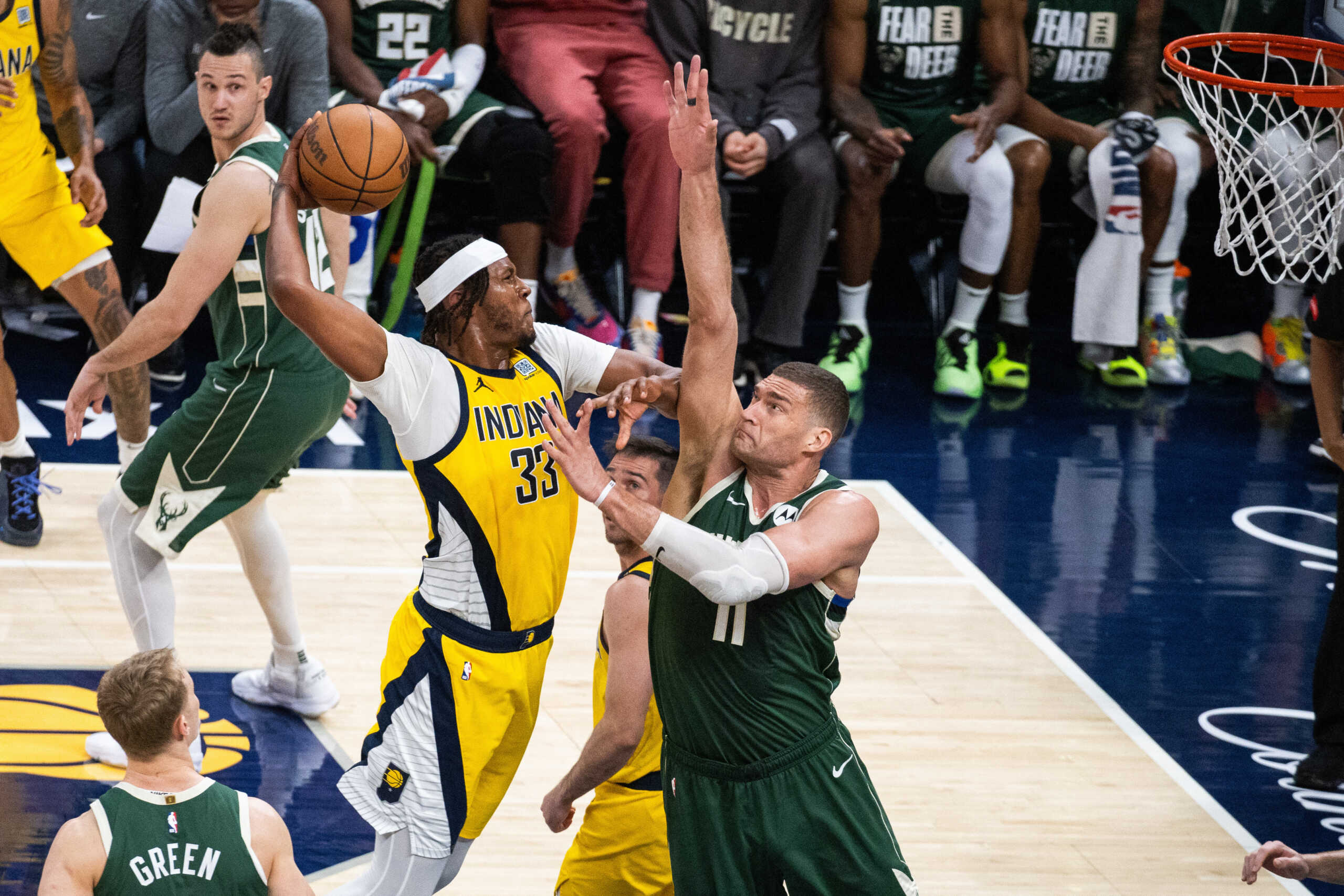 Apr 28, 2024; Indianapolis, Indiana, USA; Indiana Pacers center Myles Turner (33) shoots the ball while Milwaukee Bucks center Brook Lopez (11) defends during game four of the first round for the 2024 NBA playoffs at Gainbridge Fieldhouse. Mandatory Credit: Trevor Ruszkowski-USA TODAY Sports