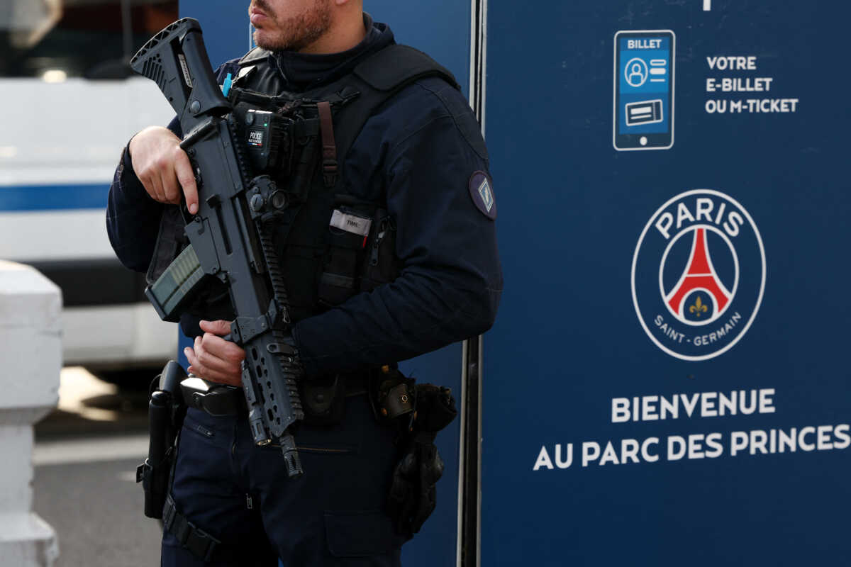 Soccer Football - Champions League - Quarter Final - First Leg - Paris St Germain v FC Barcelona - Parc des Princes, Paris, France - April 10, 2024 An armed police officer is seen outside the stadium ahead of the match REUTERS