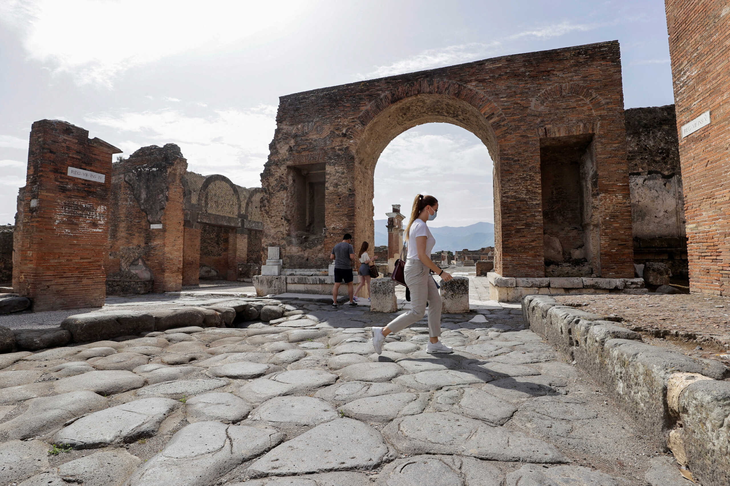 FILE PHOTO: Tourists visit the archaeological site of the ancient Roman city of Pompeii, as it reopens to the public after much of the country became a "yellow zone", loosening coronavirus disease (COVID-19) restrictions, in Pompeii, Italy, April 27, 2021. REUTERS