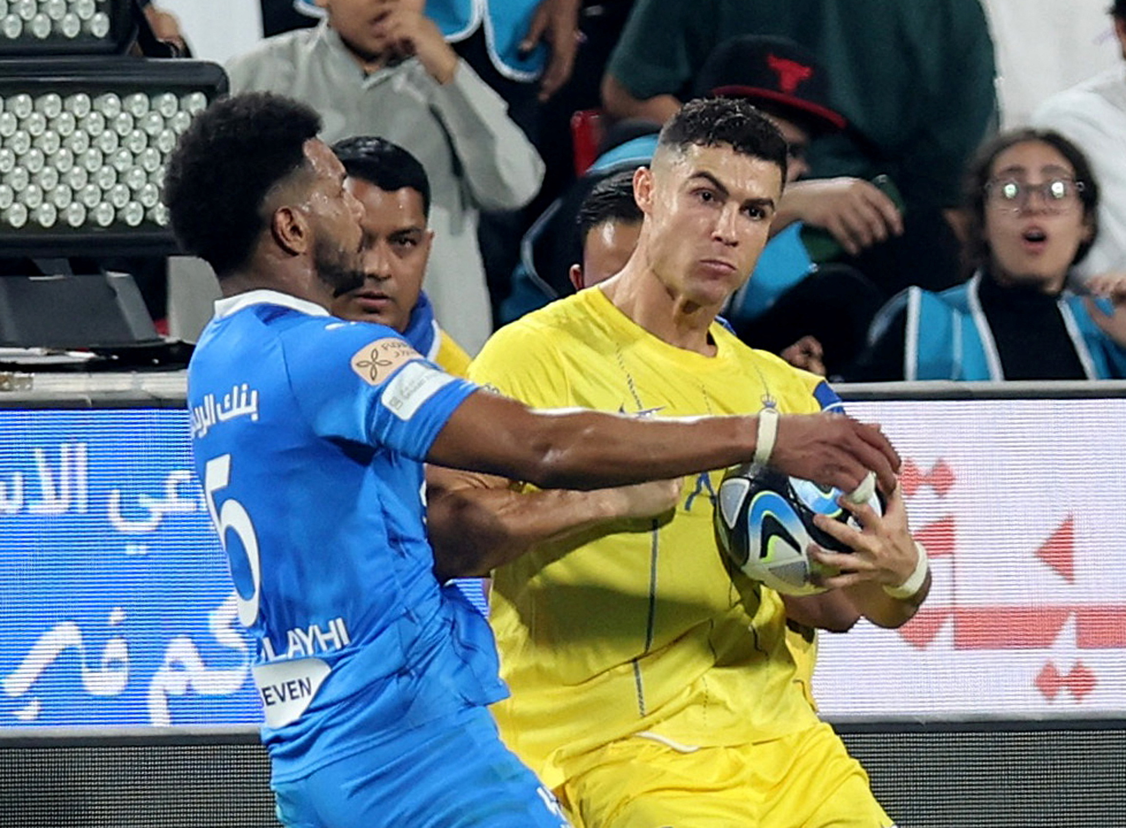 Soccer Football - Saudi Super Cup - Semi Final - Al Hilal v Al Nassr - Mohammed bin Zayed Stadium, Abu Dhabi, United Arab Emirates - April 9, 2024 Al Nassr's Cristiano Ronaldo clashes with Al Hilal's Ali Al Bulayhi before being shown a red card by referee Mohammed Al Hoaish  REUTERS