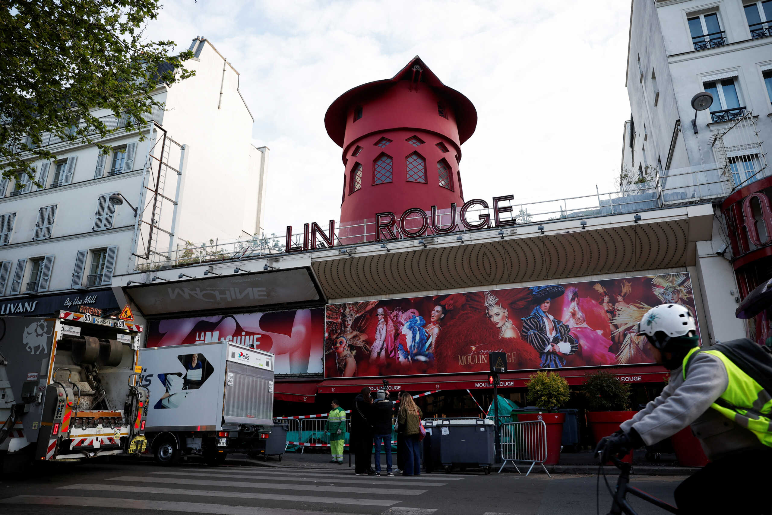 Sails of the landmark red windmill atop the Moulin Rouge, Paris' most famous cabaret club, are seen on the ground after a fall off during the night in Paris, France, April 25, 2024. REUTERS