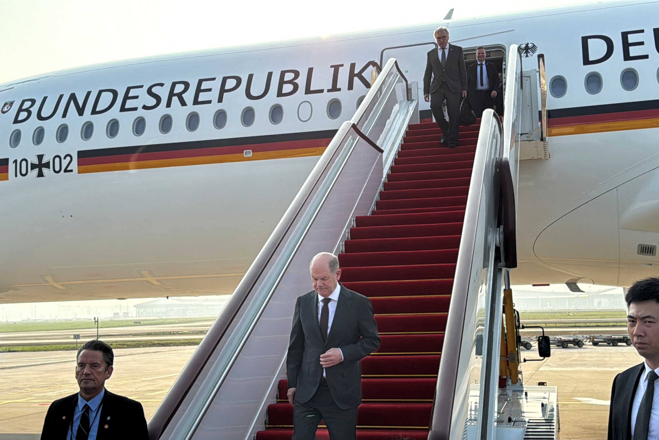 German Chancellor Olaf Scholz arrives at the airport in Chongqing, China April 14, 2024. REUTERS