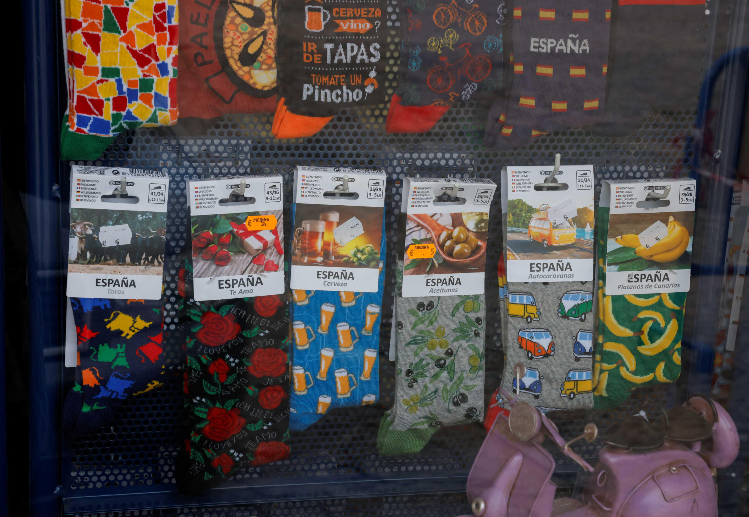 Socks with typical Spanish designs are displayed with the price in Euros on a showcase of a souvenir shop in Ronda, Spain, March 14, 2024. REUTERS