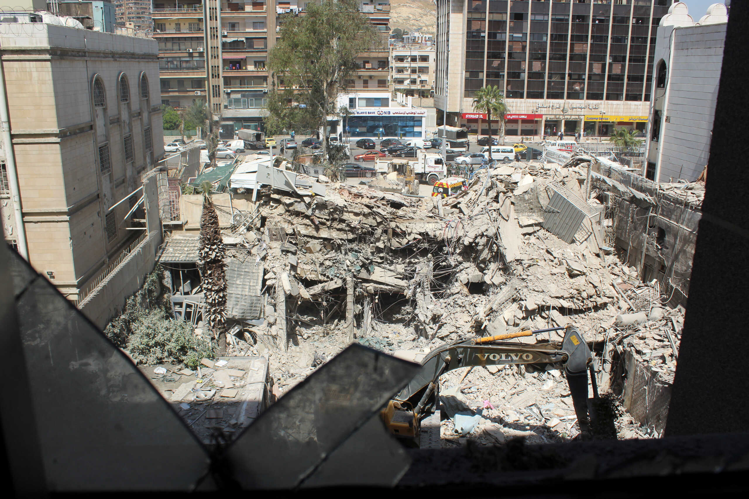 An excavator clears rubble after a suspected Israeli strike on Monday on Iran's consulate, adjacent to the main Iranian embassy building, which Iran said had killed seven military personnel including two key figures in the Quds Force, in the Syrian capital Damascus, Syria April 2, 2024. REUTERS