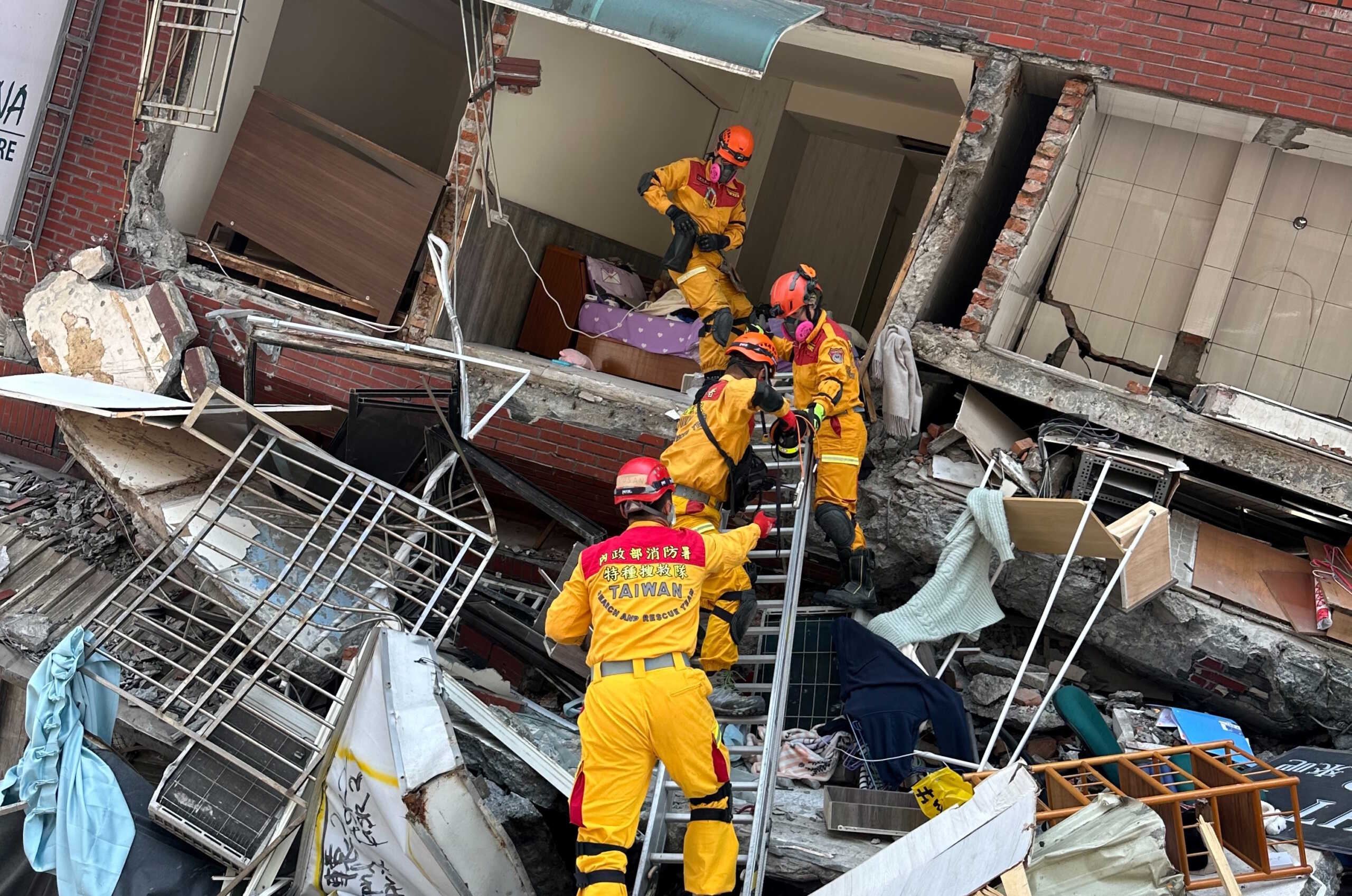 Firefighters work at the site where a building collapsed following the earthquake, in Hualien, Taiwan, in this handout provided by Taiwan's National Fire Agency on April 3, 2024. Taiwan National Fire Agency