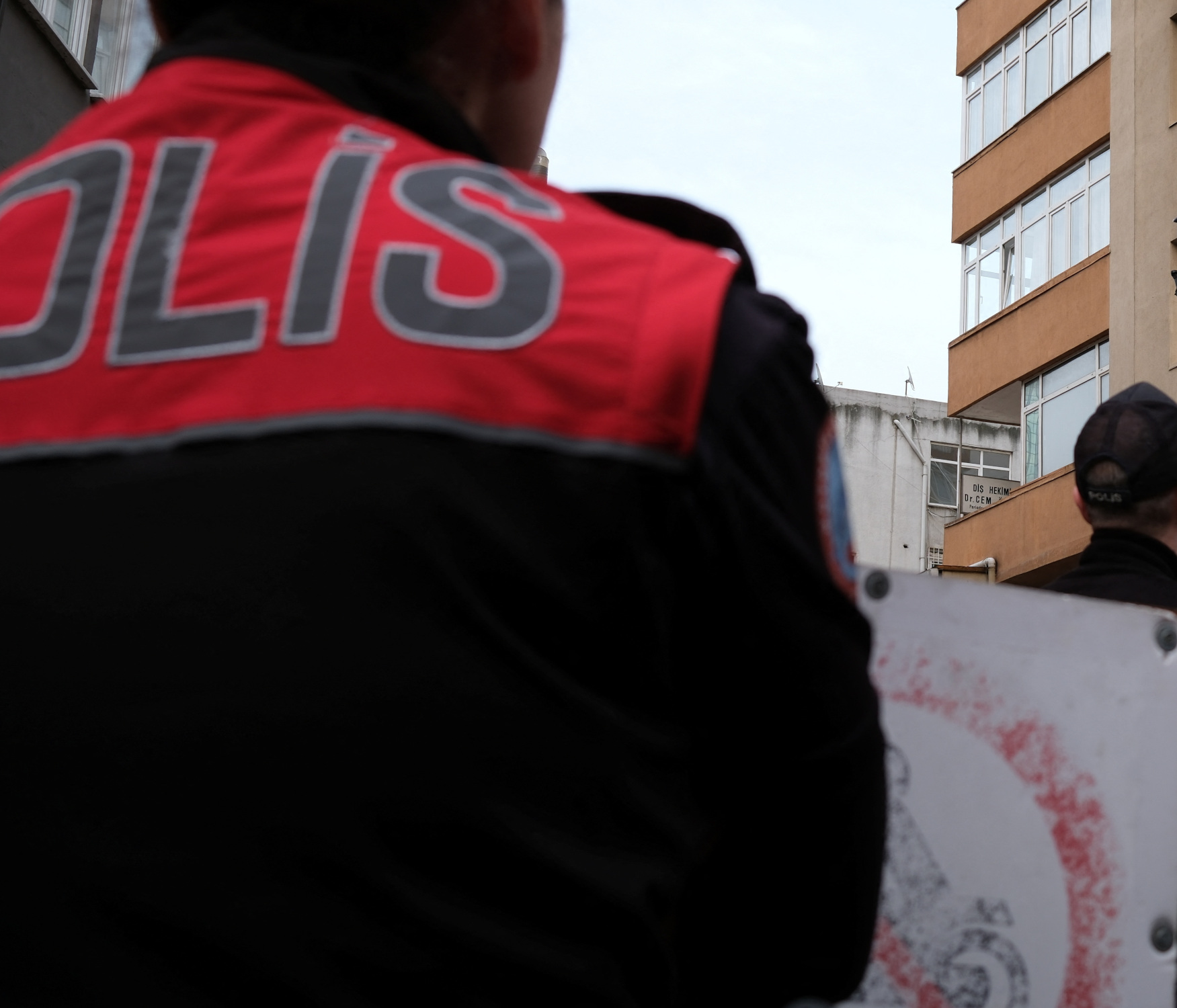 Firefighters work, as police officers and police forensic experts stand in front of a building where a fire broke out during daytime renovation work at a nightclub in Istanbul, Turkey April 2, 2024. REUTERS