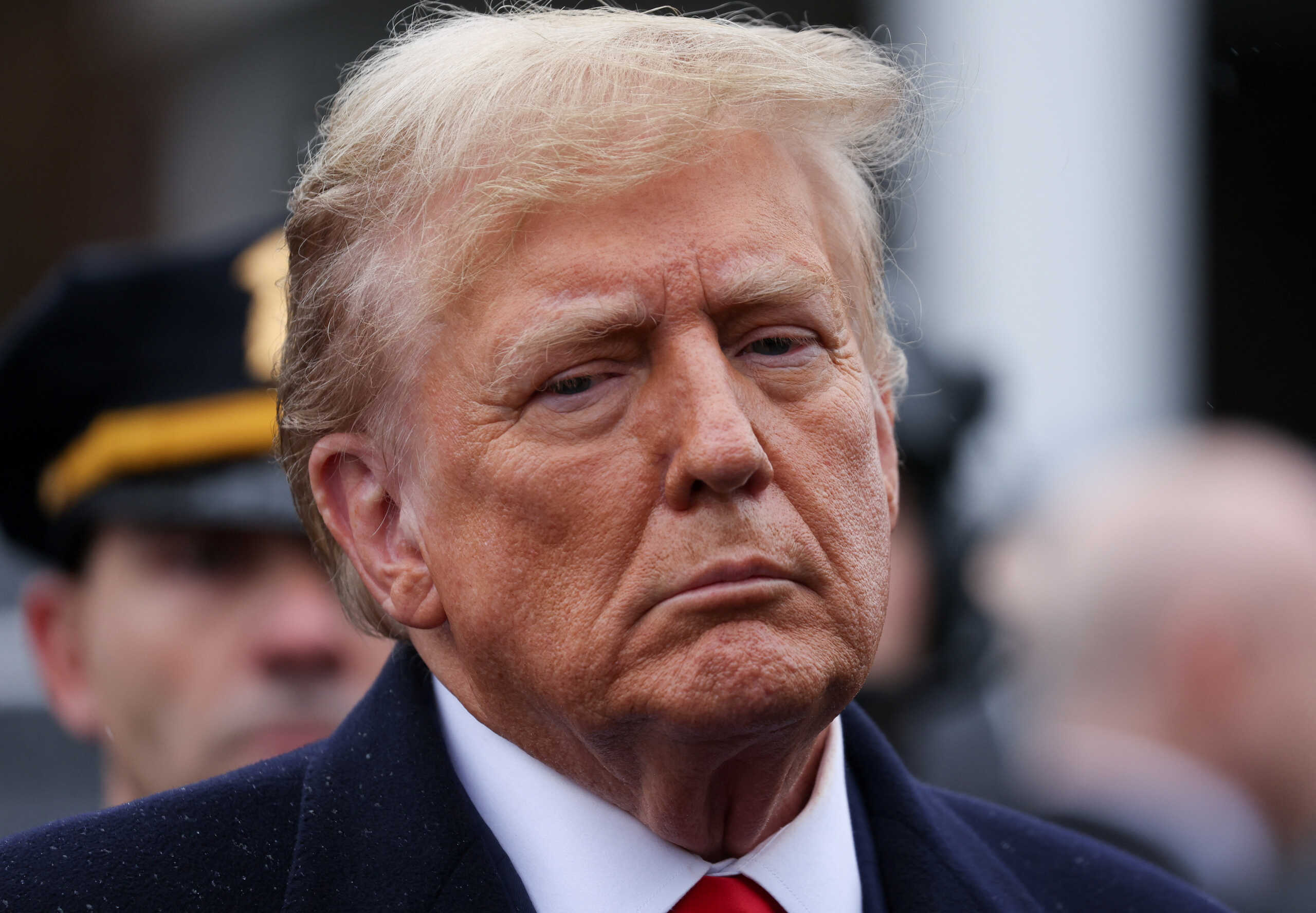 Former U.S. President Donald Trump looks on after attending a wake for New York City Police Department (NYPD) officer Jonathan Diller, who was shot and killed while making a routine traffic stop on March 25 in the Far Rockaway section of Queens, in Massapequa Park, New York, U.S., March 28, 2024. REUTERS