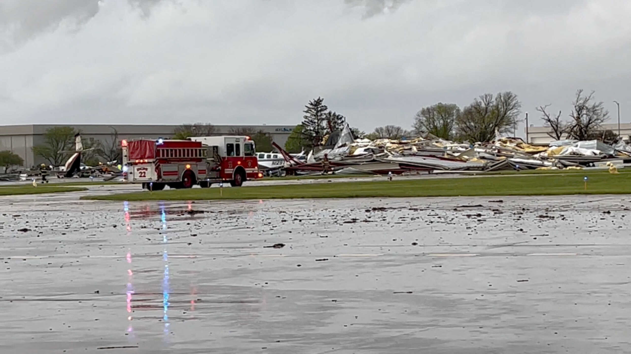 Emergency personnel work next to the damages caused by a tornado at Eppley Airfield, in Omaha, Nebraska, U.S. April 26, 2024, in this still image obtained from a social media video. X@Sky360s