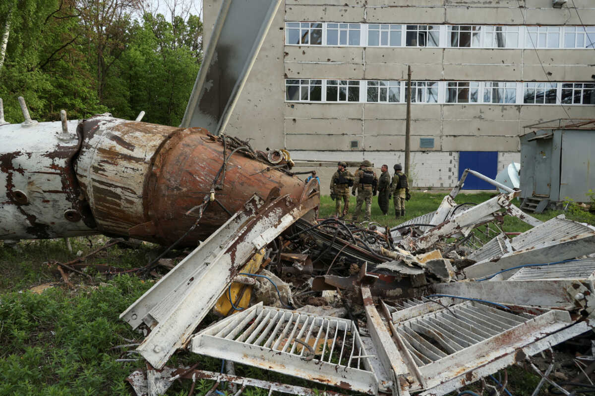 Police officers stand next to a part of a television tower partially destroyed by a Russian missile strike, amid Russia's attack on Ukraine, in Kharkiv, Ukraine April 22, 2024. REUTERS