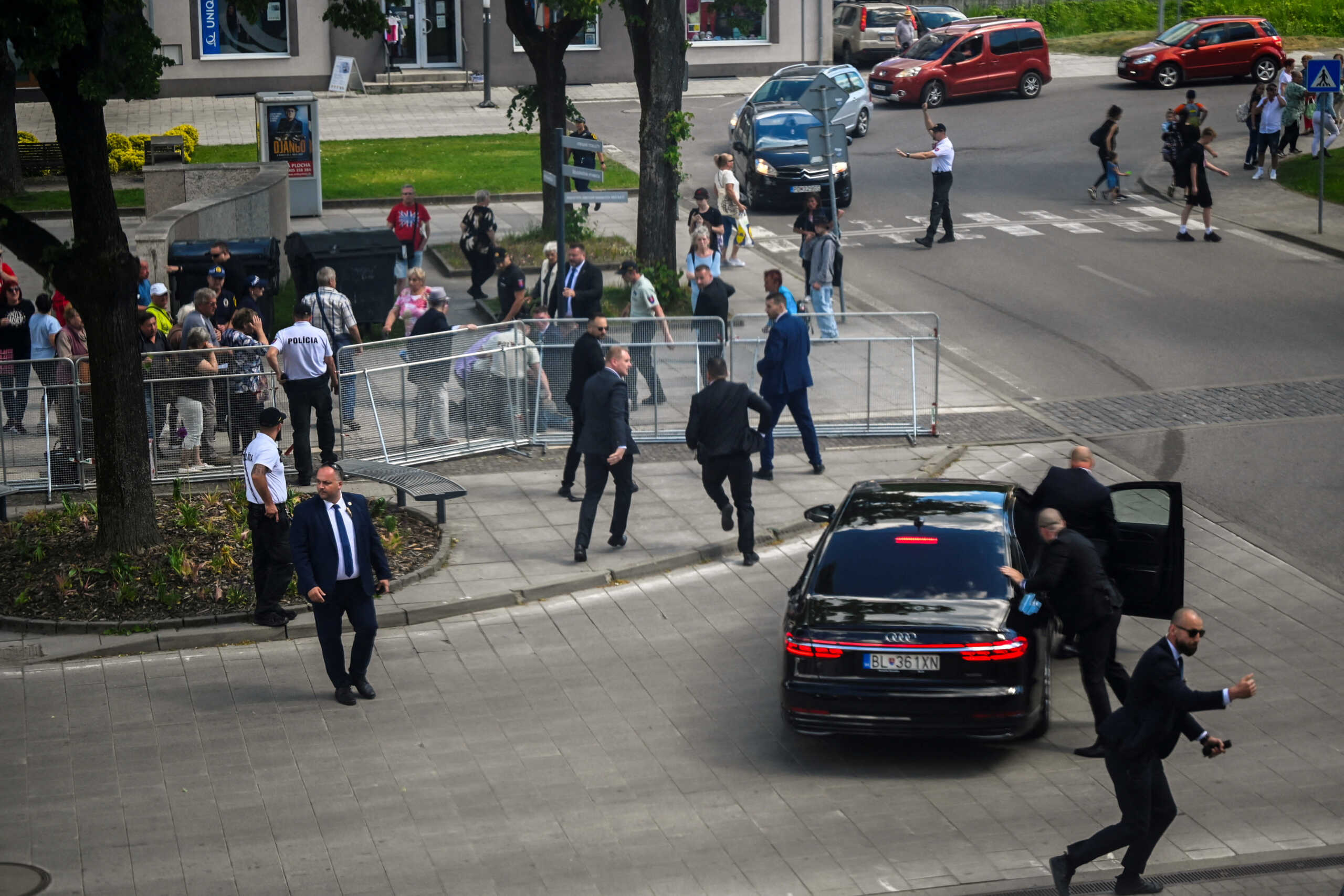 FILE PHOTO: Security officers move Slovakia's Prime Minister Robert Fico into a car after he was shot at close range in an assassination attempt, after a government meeting in Handlova, Slovakia, May 15, 2024. REUTERS