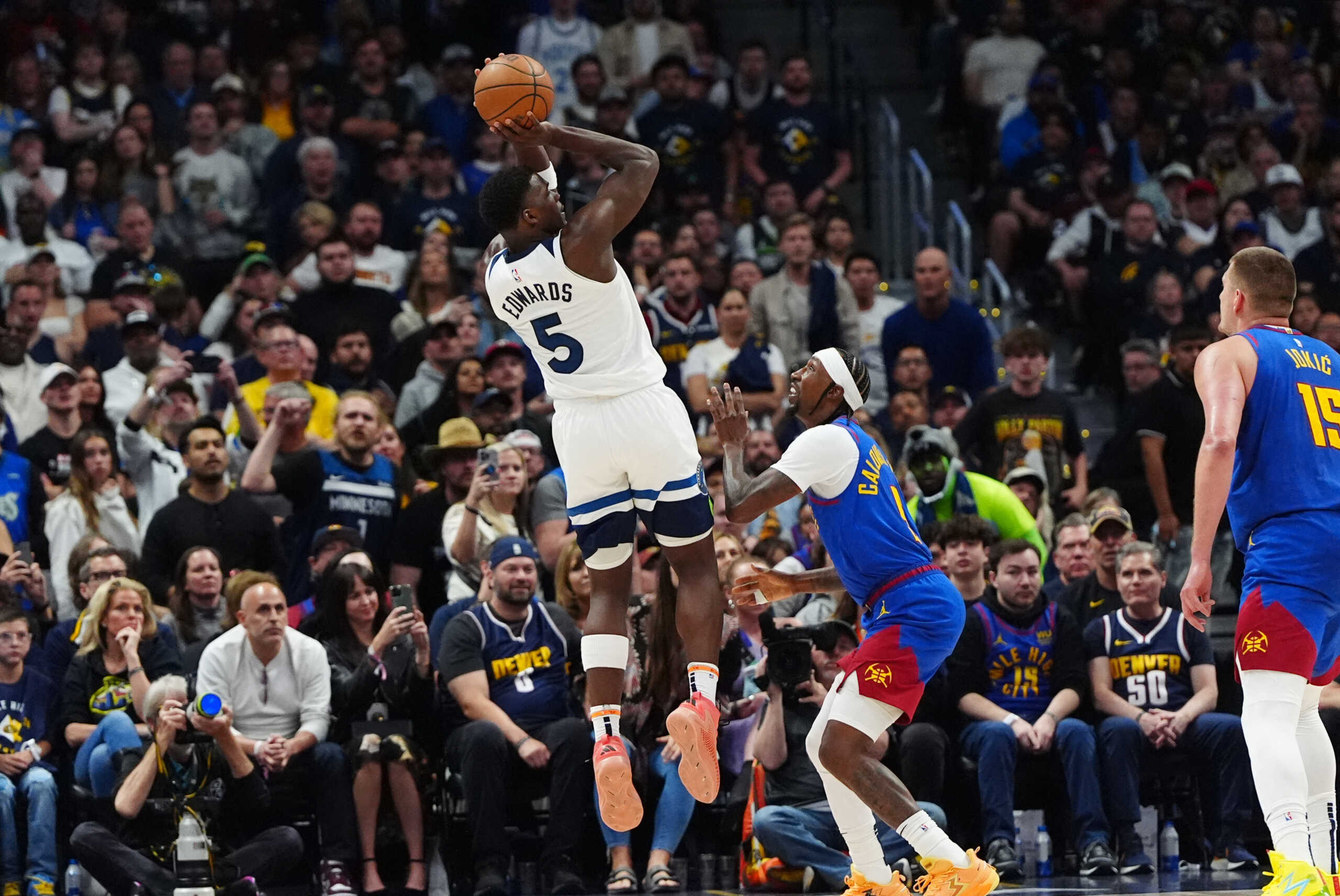 May 4, 2024; Denver, Colorado, USA; Minnesota Timberwolves guard Anthony Edwards (5) shoots the ball over Denver Nuggets guard Kentavious Caldwell-Pope (5) in the fourth quarter during game one of the second round for the 2024 NBA playoffs at Ball Arena. Mandatory Credit: Ron Chenoy-USA TODAY Sports