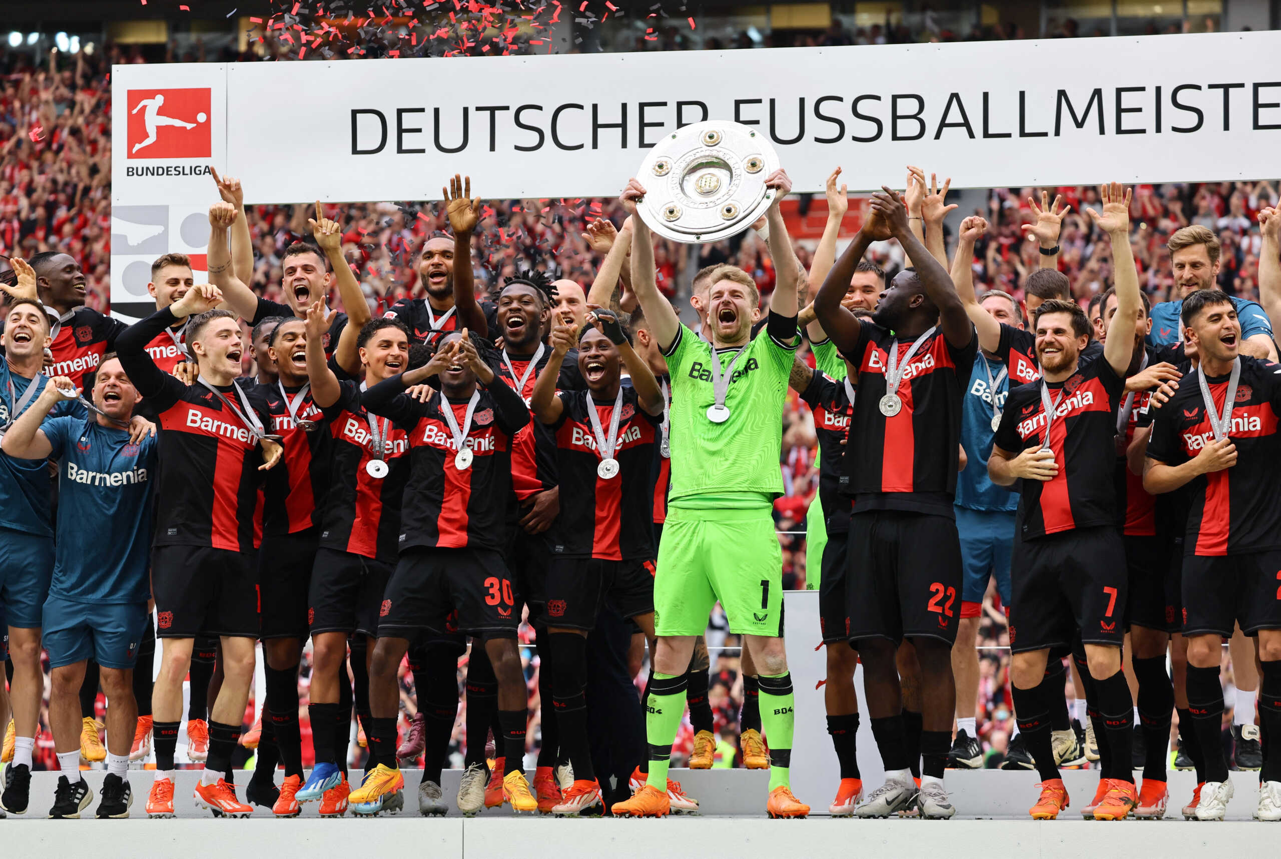 Soccer Football - Bundesliga - Bayer Leverkusen v FC Augsburg - BayArena, Leverkusen, Germany - May 18, 2024 Bayer Leverkusen's Lukas Hradecky lifts the trophy as he celebrates with teammates after winning the Bundesliga and going unbeaten REUTERS