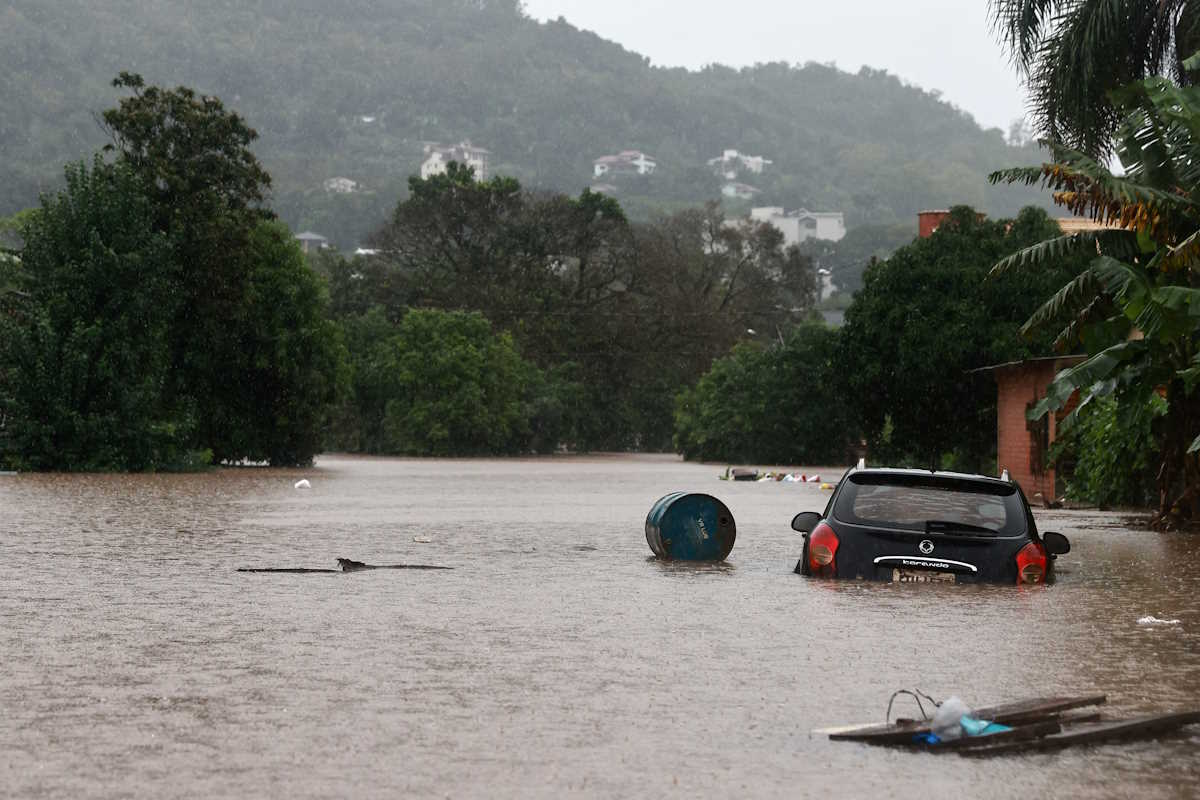 A car stands in the flooding water of the Taquari River during heavy rains in the city of Encantado in Rio Grande do Sul, Brazil, May 1, 2024. REUTERS