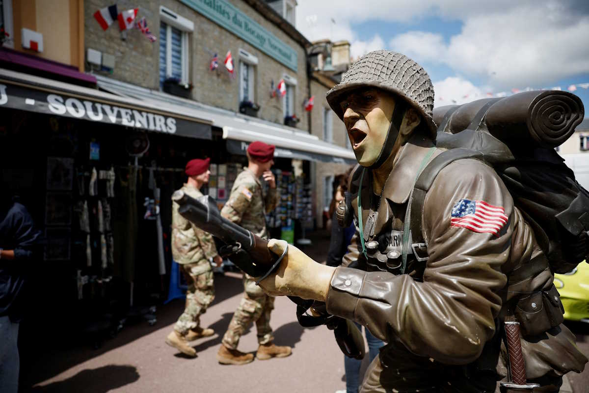 US soldiers are seen near the church of Sainte-Mere-Eglise where John Marvin Steele, an American paratrooper landed on the pinnacle of the church tower in Sainte-Mere-Eglise, Normandy region, France, May 30, 2024. REUTERS