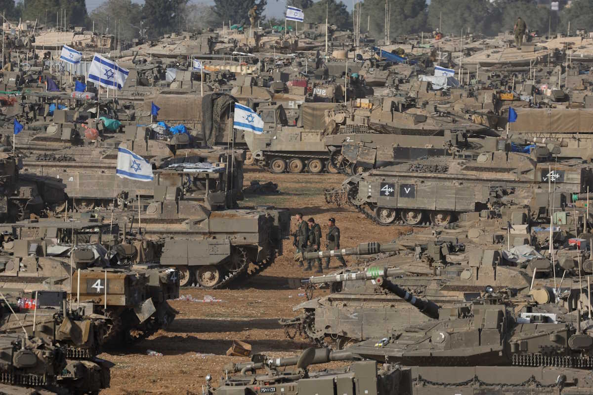 Israeli soldiers walk amid military vehicles, amid the ongoing conflict between Israel and the Palestinian Islamist group Hamas, near the Israel-Gaza Border, in southern Israel, May 9, 2024. REUTERS
