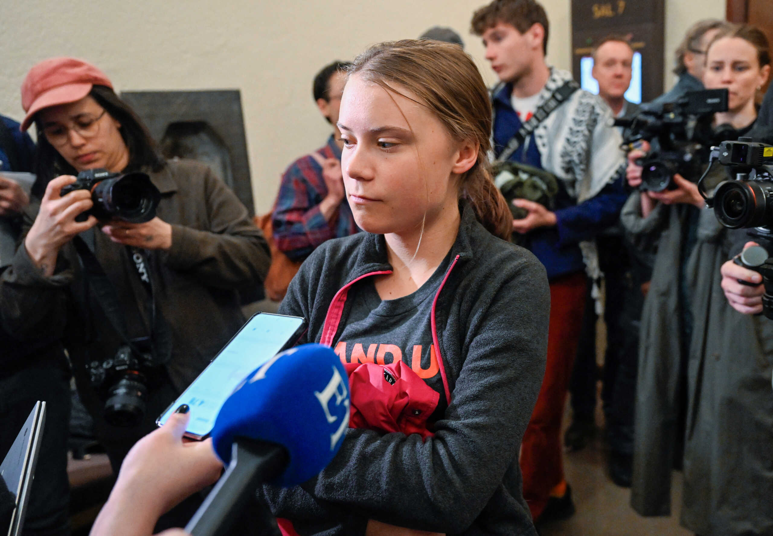 Greta Thunberg speaks to reporters in the Stockholm district court, which is holding the main hearing in the case where the climate activist is charged with two cases of disobedience to the authorities after protest actions at the Riksdag, in Stockholm, Sweden, May 8, 2024. Fredrik Sandberg