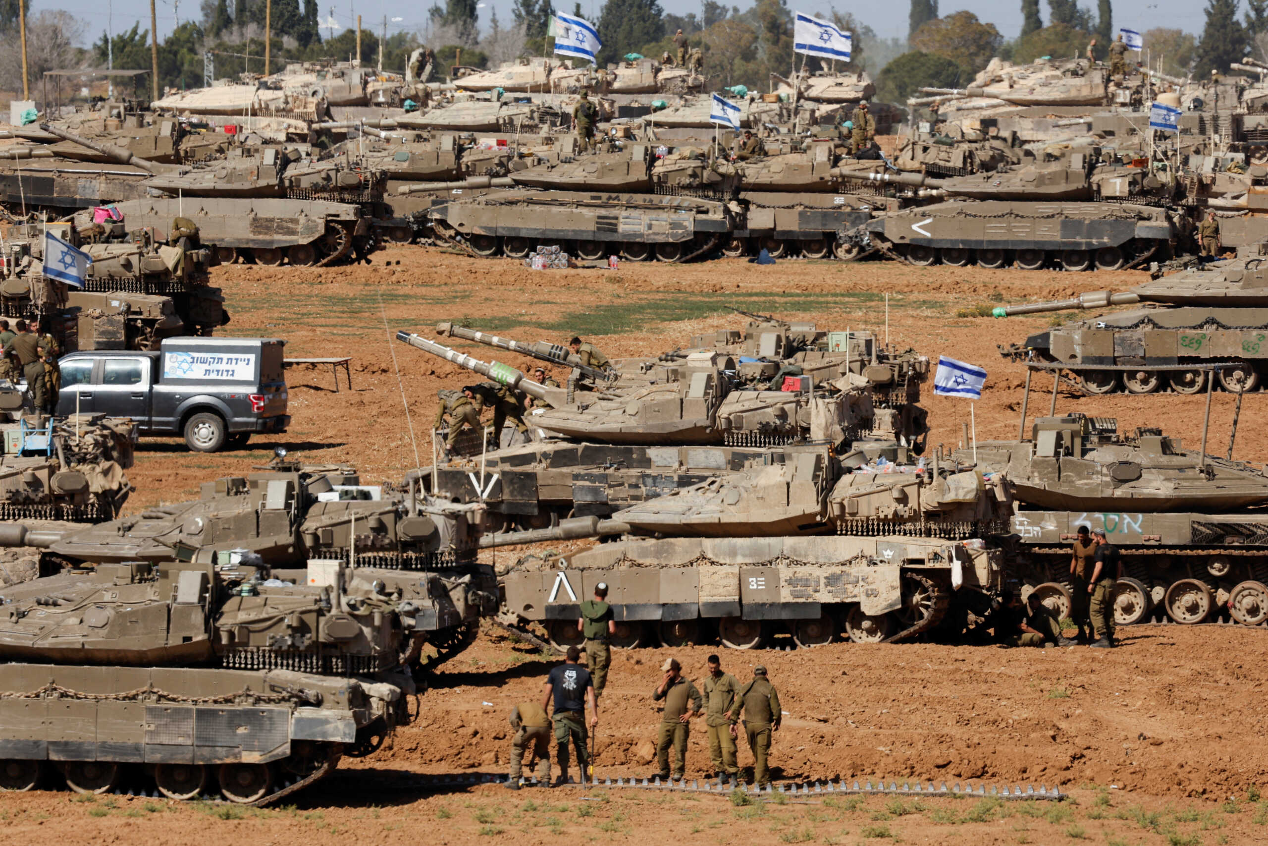 Israeli soldiers stand next to military vehicles, amid the ongoing conflict between Israel and the Palestinian Islamist group Hamas, near the Israel-Gaza Border, in southern Israel, May 7, 2024. REUTERS