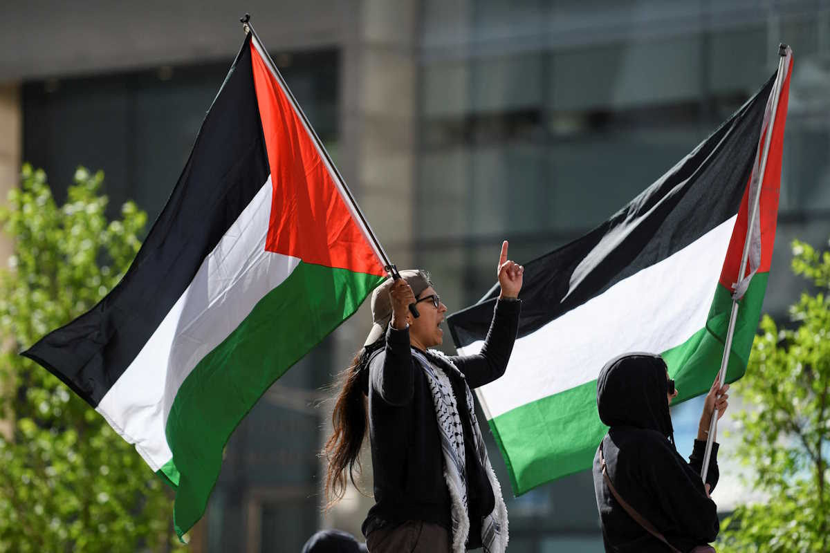 Protesters wave Palestinian flags as students and workers hold a pro-Palestinian rally outside MIT's Stata Center, demanding MIT divest from Israel, among other demands, in Cambridge, Massachusetts, U.S. May 9, 2024. REUTERS