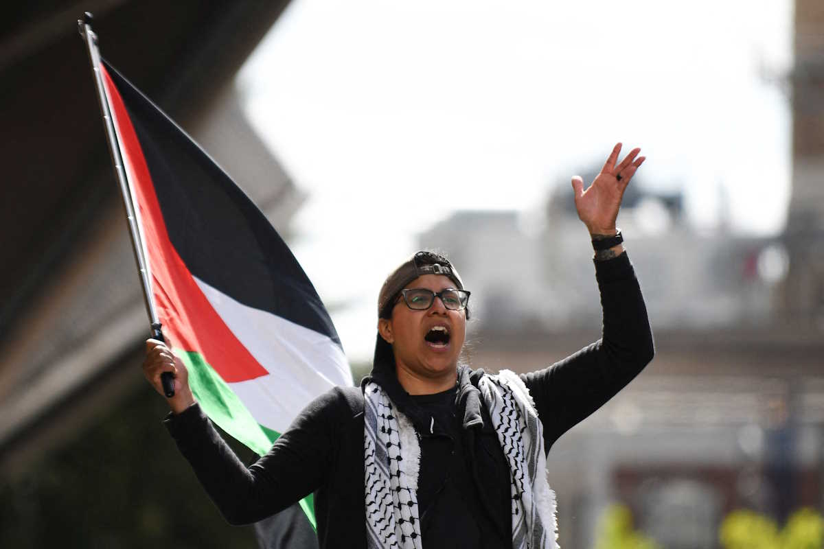 A protester waves a Palestinian flag as students and workers hold a pro-Palestinian rally outside MIT's Stata Center, demanding MIT divest from Israel, among other demands, in Cambridge, Massachusetts, U.S. May 9, 2024. REUTERS