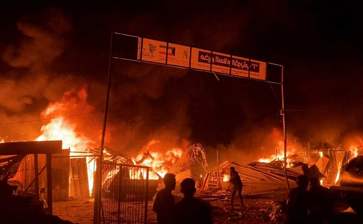 Fire rages following an Israeli strike on an area designated for displaced Palestinians, amid the ongoing conflict between Israel and Hamas, in Rafah in the southern Gaza Strip, in this still picture taken from a video, May 26, 2024. REUTERS