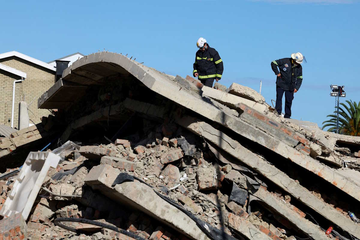 FILE PHOTO: Rescuers work to rescue construction workers trapped under a building that collapsed in George, South Africa May 8, 2024. REUTERS