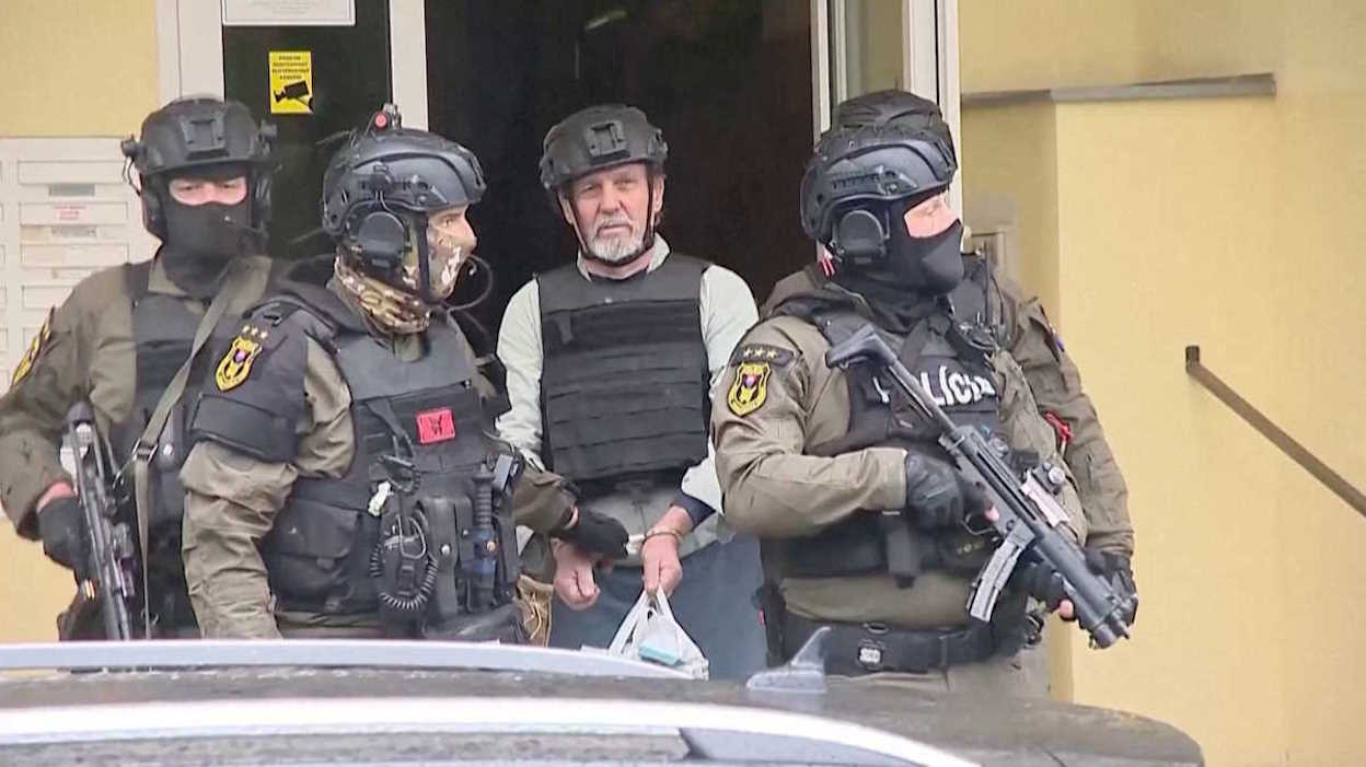 Police officers escort a man suspected of conducting the shooting attack on Slovak Prime Minister Robert Fico, identified by the prosecution as Juraj C., in Levice, Slovakia, May 17, 2024, in this still image obtained from a video. Markiza TV