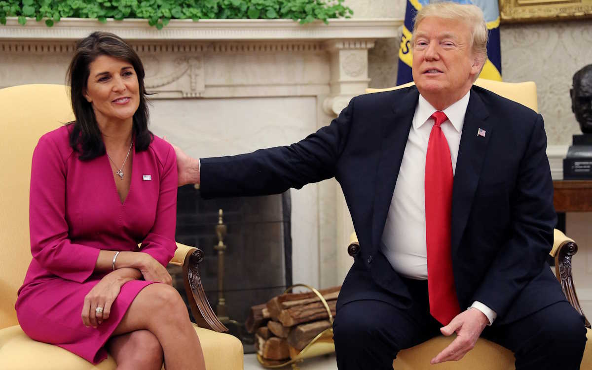 FILE PHOTO: U.S. President Donald Trump reaches out to outgoing U.S. Ambassador to the United Nations Nikki Haley as they meet in the Oval Office of the White House after the president accepted Haley's resignation in Washington, U.S., October 9, 2018. REUTERS