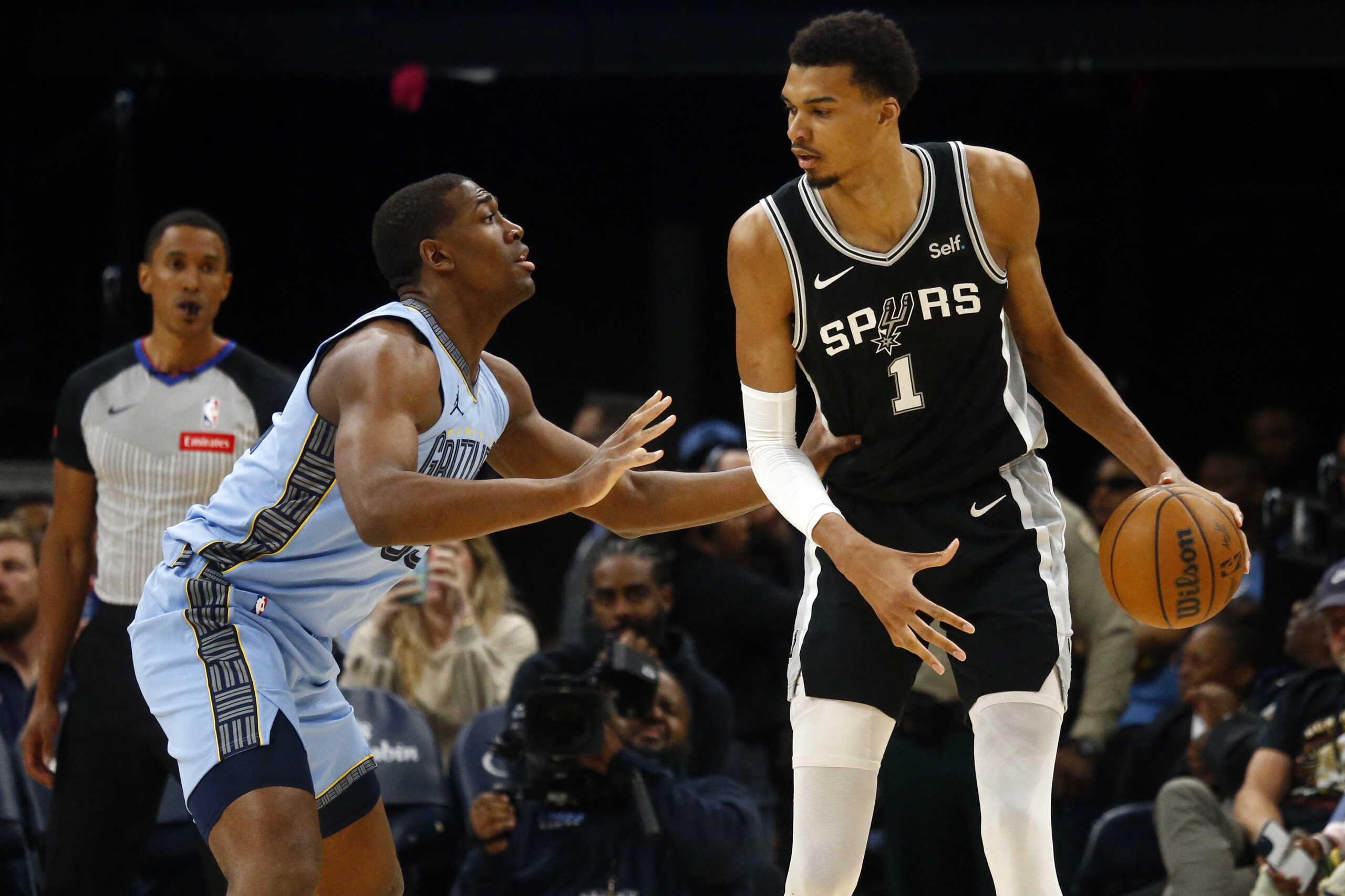 Apr 9, 2024; Memphis, Tennessee, USA; San Antonio Spurs center Victor Wembanyama (1) handles the ball as Memphis Grizzlies center Trey Jemison (55) defends during the first half at FedExForum. Mandatory Credit: Petre Thomas-USA TODAY Sports