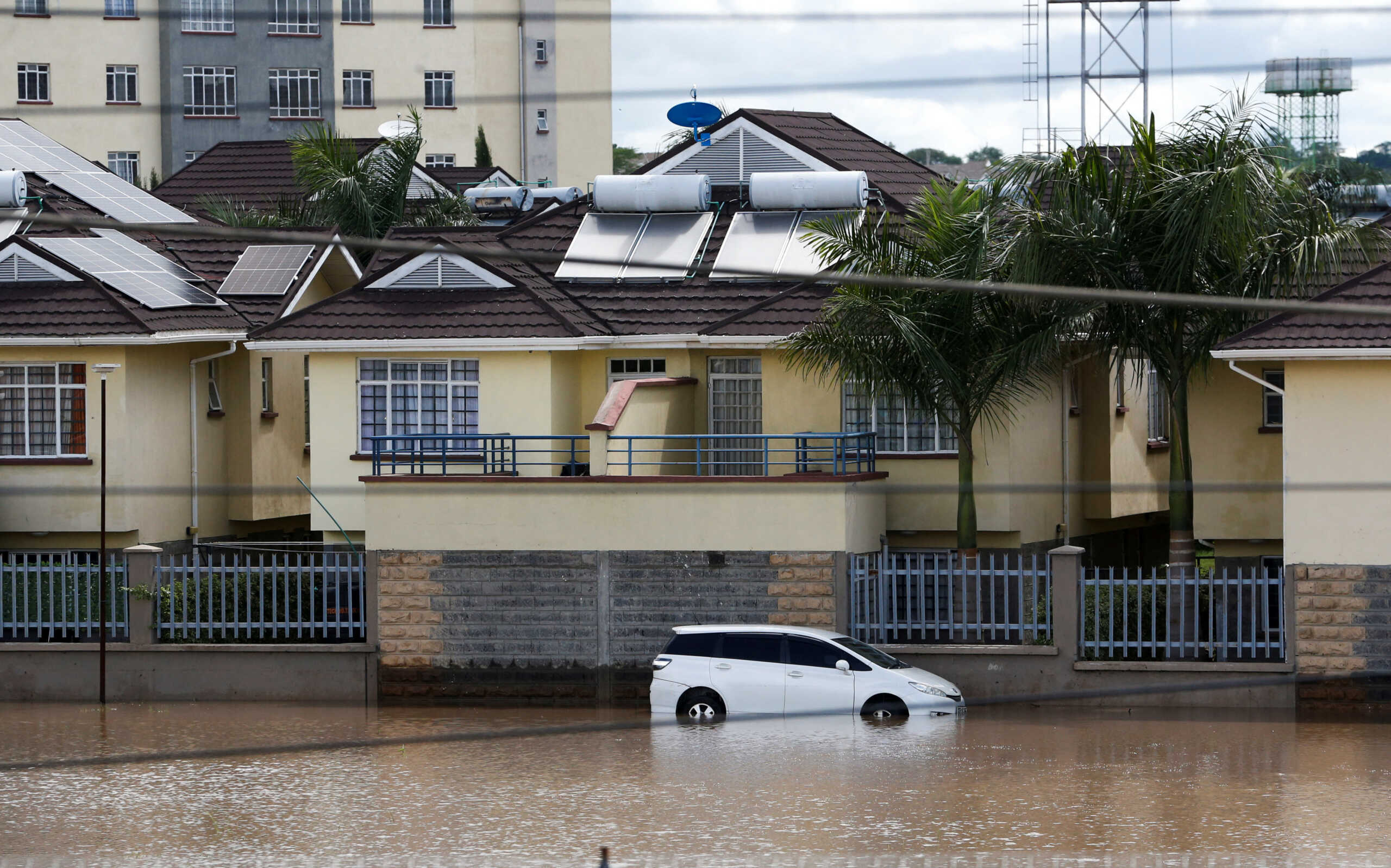 A view of a vehicle partially submerged in flood waters after Athi River burst its banks and marooned homes following heavy rainfall at the Crystal Park estate in Machakos county near Nairobi, Kenya April 24, 2024. REUTERS