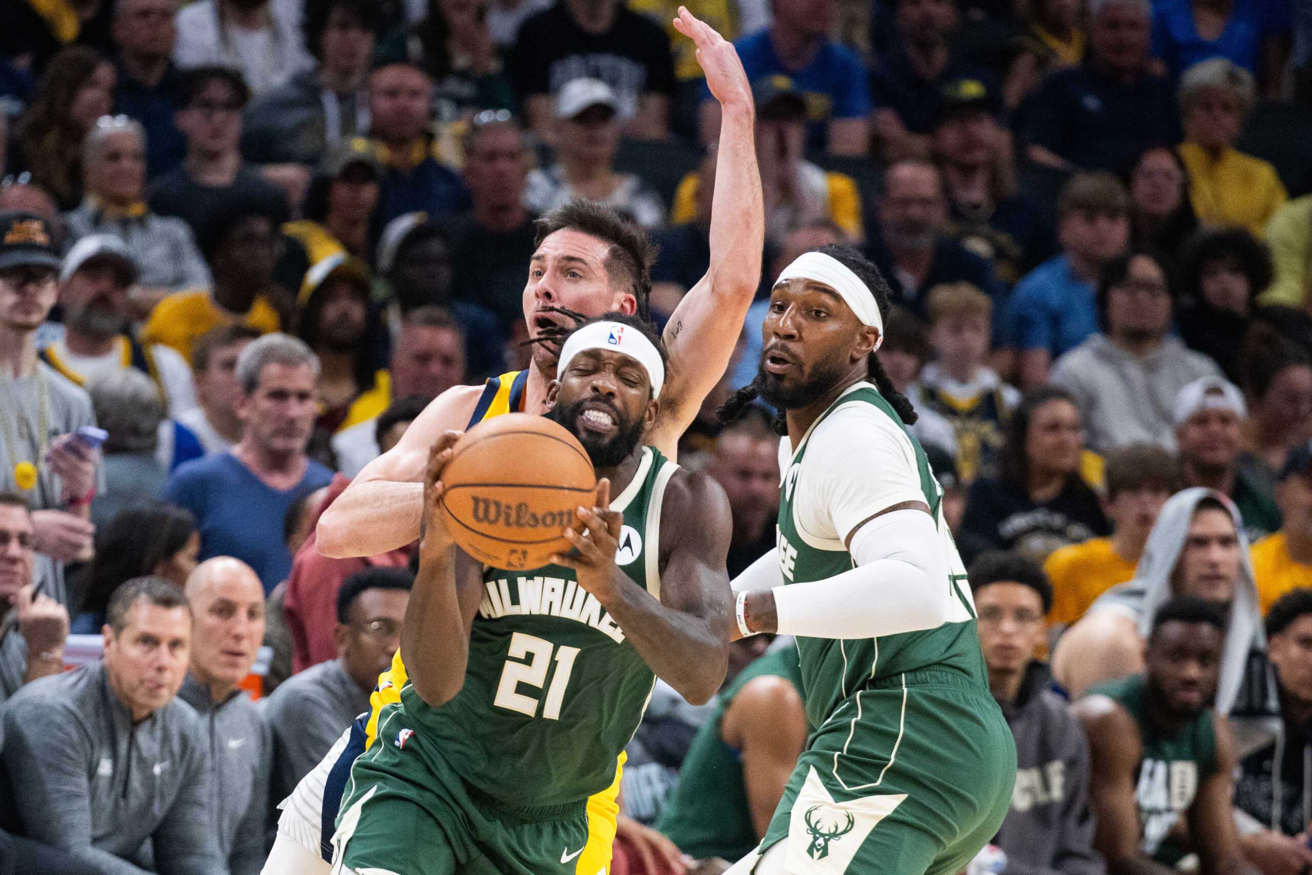 Apr 28, 2024; Indianapolis, Indiana, USA; Milwaukee Bucks guard Patrick Beverley (21) catches the ball while Indiana Pacers guard T.J. McConnell (9) defends during game four of the first round for the 2024 NBA playoffs at Gainbridge Fieldhouse. Mandatory Credit: Trevor Ruszkowski-USA TODAY Sports