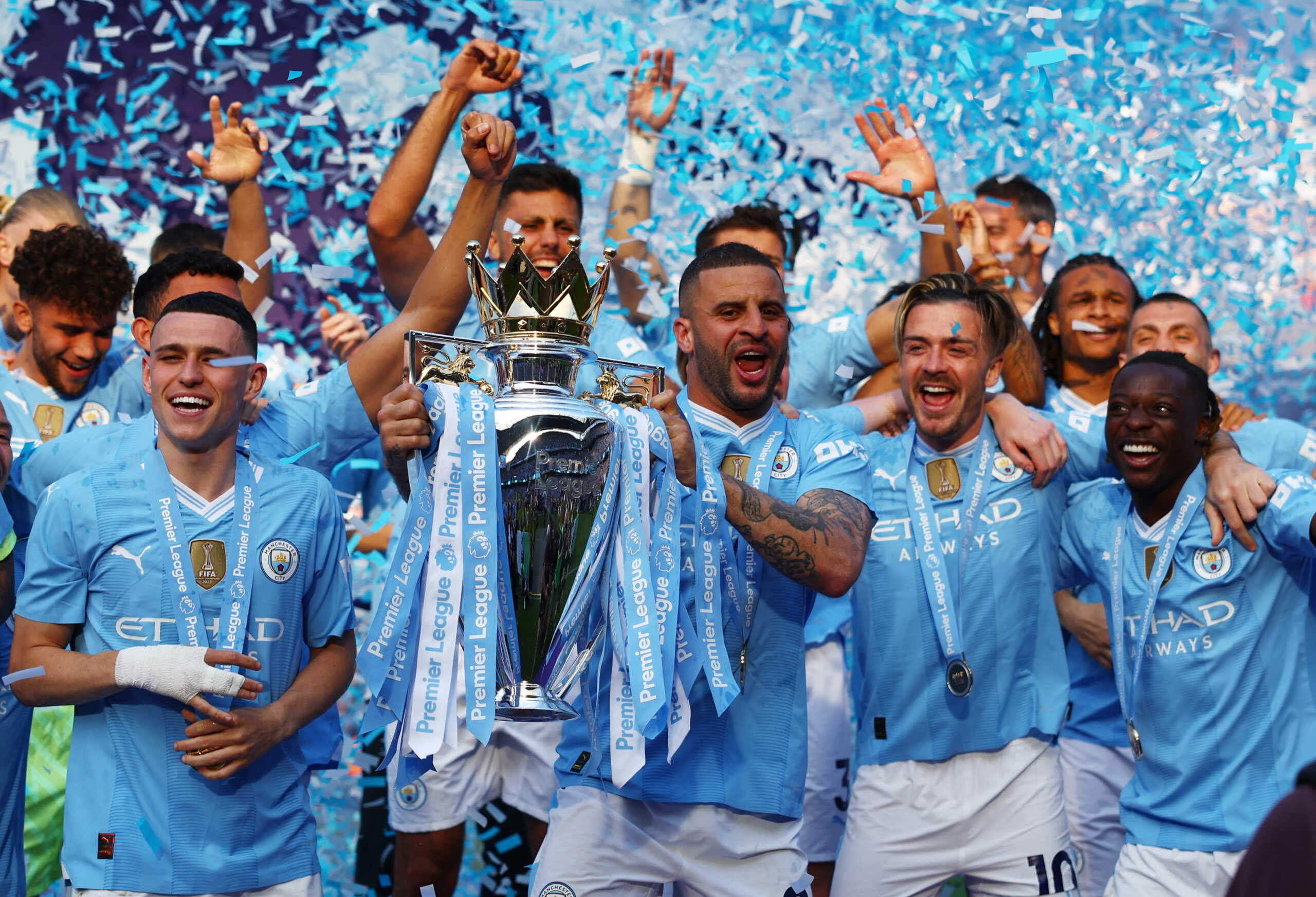 Soccer Football - Premier League - Manchester City v West Ham United - Etihad Stadium, Manchester, Britain - May 19, 2024  Manchester City's Kyle Walker, Phil Foden, Jack Grealish and Jeremy Doku celebrate with the trophy after winning the Premier League REUTERS