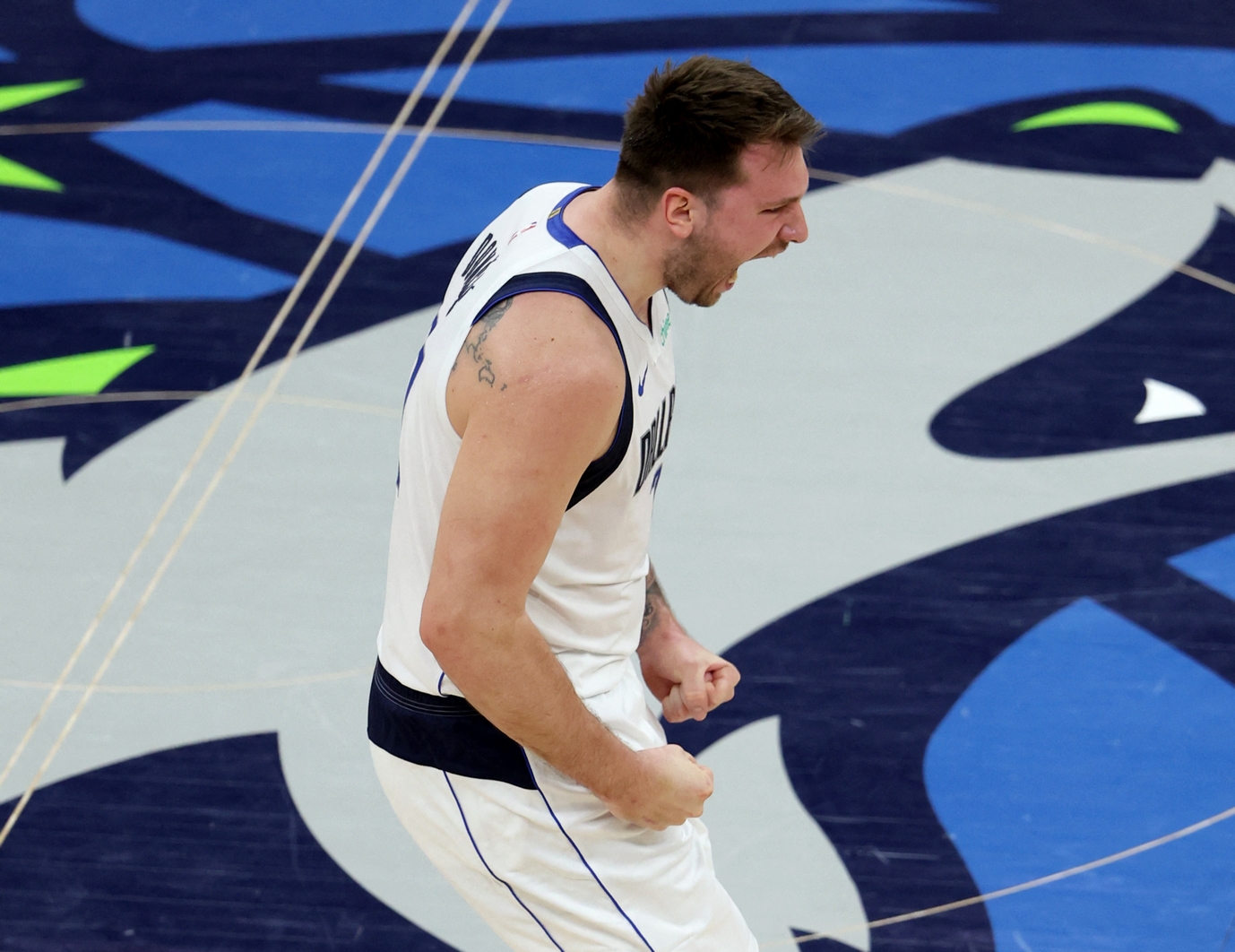May 30, 2024; Minneapolis, Minnesota, USA; Dallas Mavericks guard Luka Doncic (77) reacts after a play during the first quarter in game five of the western conference finals for the 2024 NBA playoffs against the Minnesota Timberwolves at Target Center. Mandatory Credit: Jesse Johnson-USA TODAY Sports