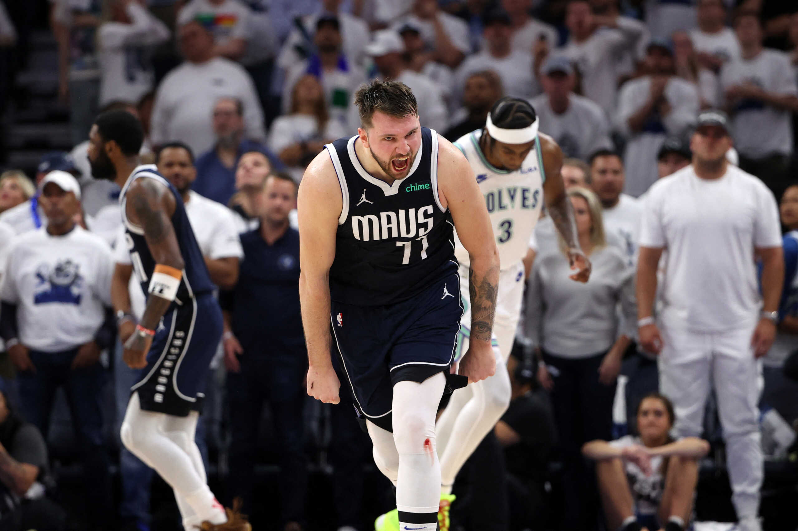 May 22, 2024; Minneapolis, Minnesota, USA; Dallas Mavericks guard Luka Doncic (77) celebrates after in the fourth quarter against the Minnesota Timberwolves in game one of the western conference finals for the 2024 NBA playoffs at Target Center. Mandatory Credit: Jesse Johnson-USA TODAY Sports