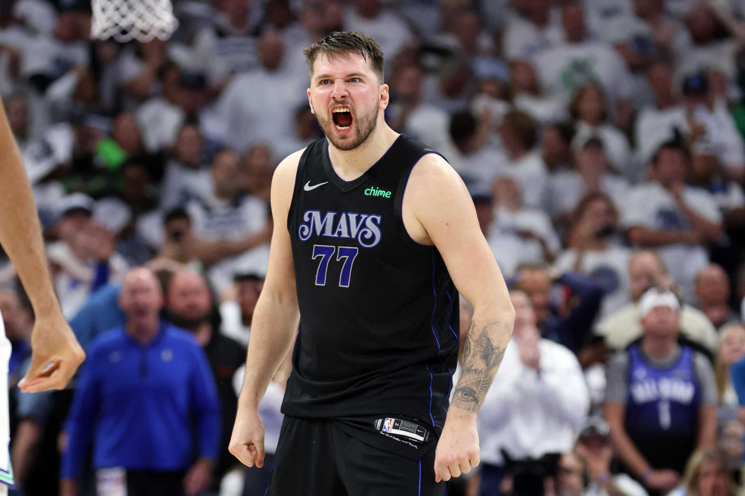 May 24, 2024; Minneapolis, Minnesota, USA; Dallas Mavericks guard Luka Doncic (77) reacts in the fourth quarter against the Minnesota Timberwolves during game two of the western conference finals for the 2024 NBA playoffs at Target Center. Mandatory Credit: Jesse Johnson-USA TODAY Sports